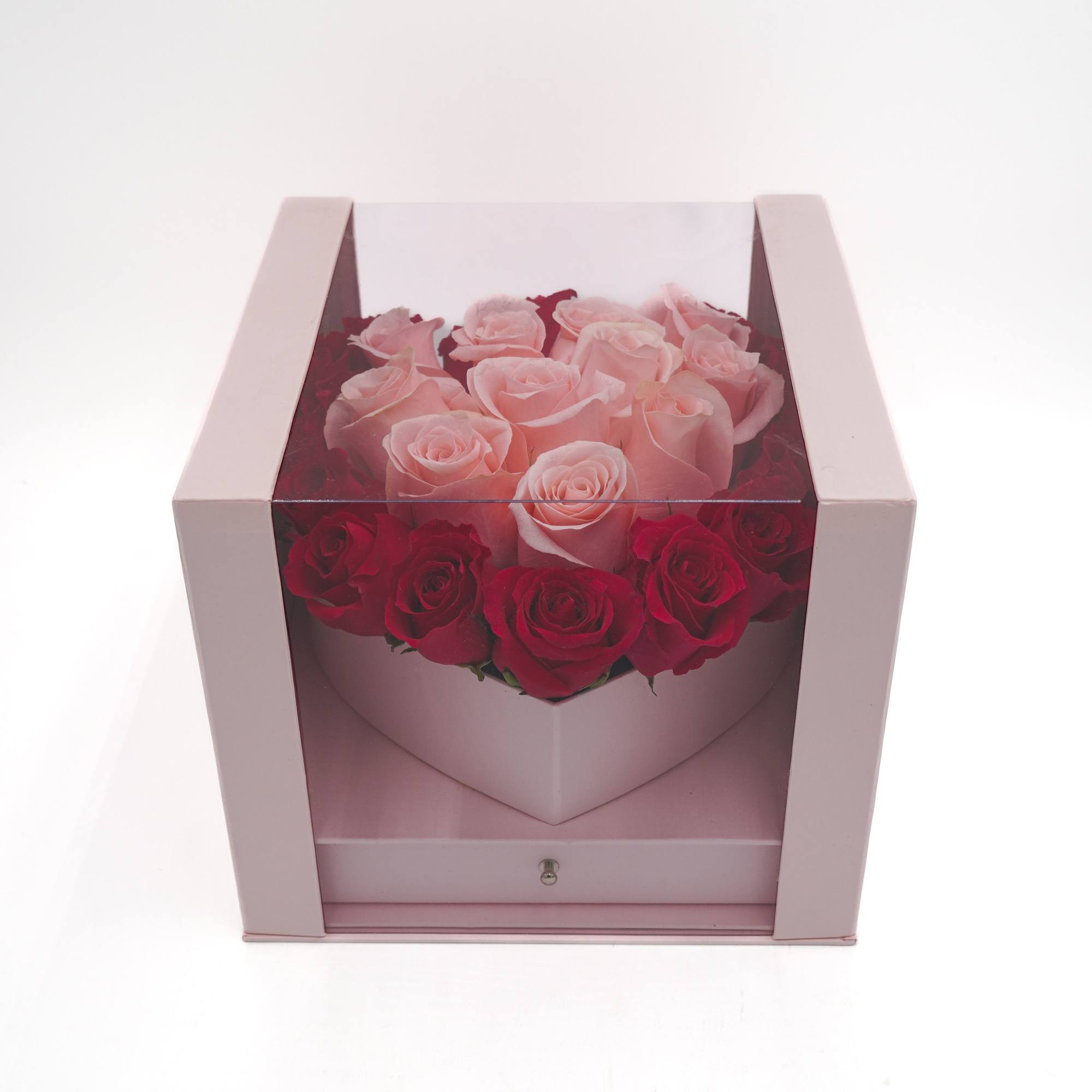 A heart-shaped arrangement of Pink and Hot Pink roses in a cube