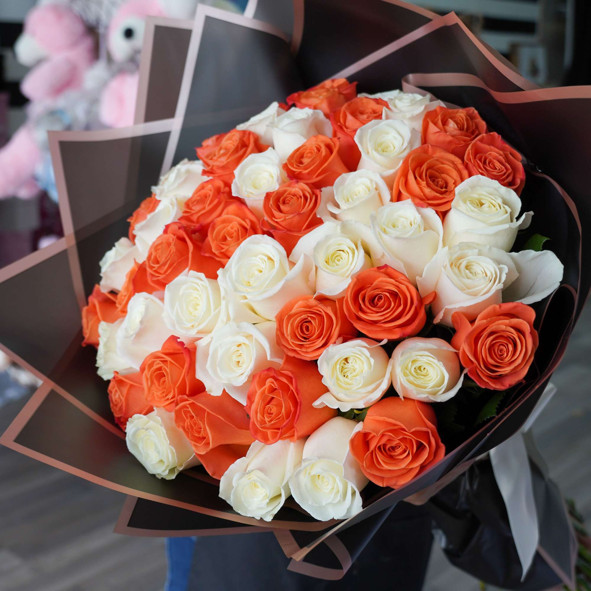 A stunning hand-tied bouquet featuring a vibrant mix of orange and white, photo 2 of 3