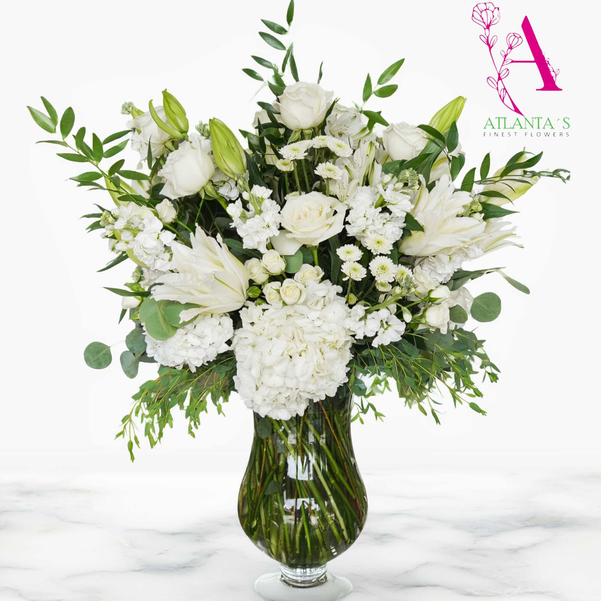 This Purest Love bouquet includes hydrangea, asiatic lilies, alstroemeria, miniature carnations, stock