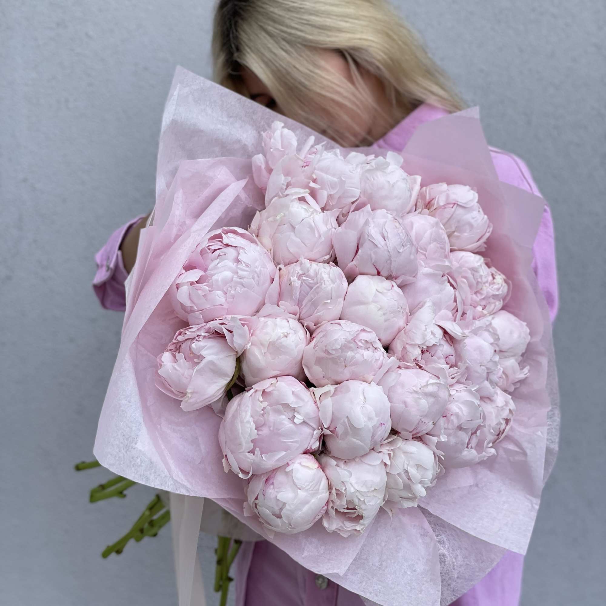 Large bouquet of pale pink peonies wrapped in pink paper, photo 7 of 10