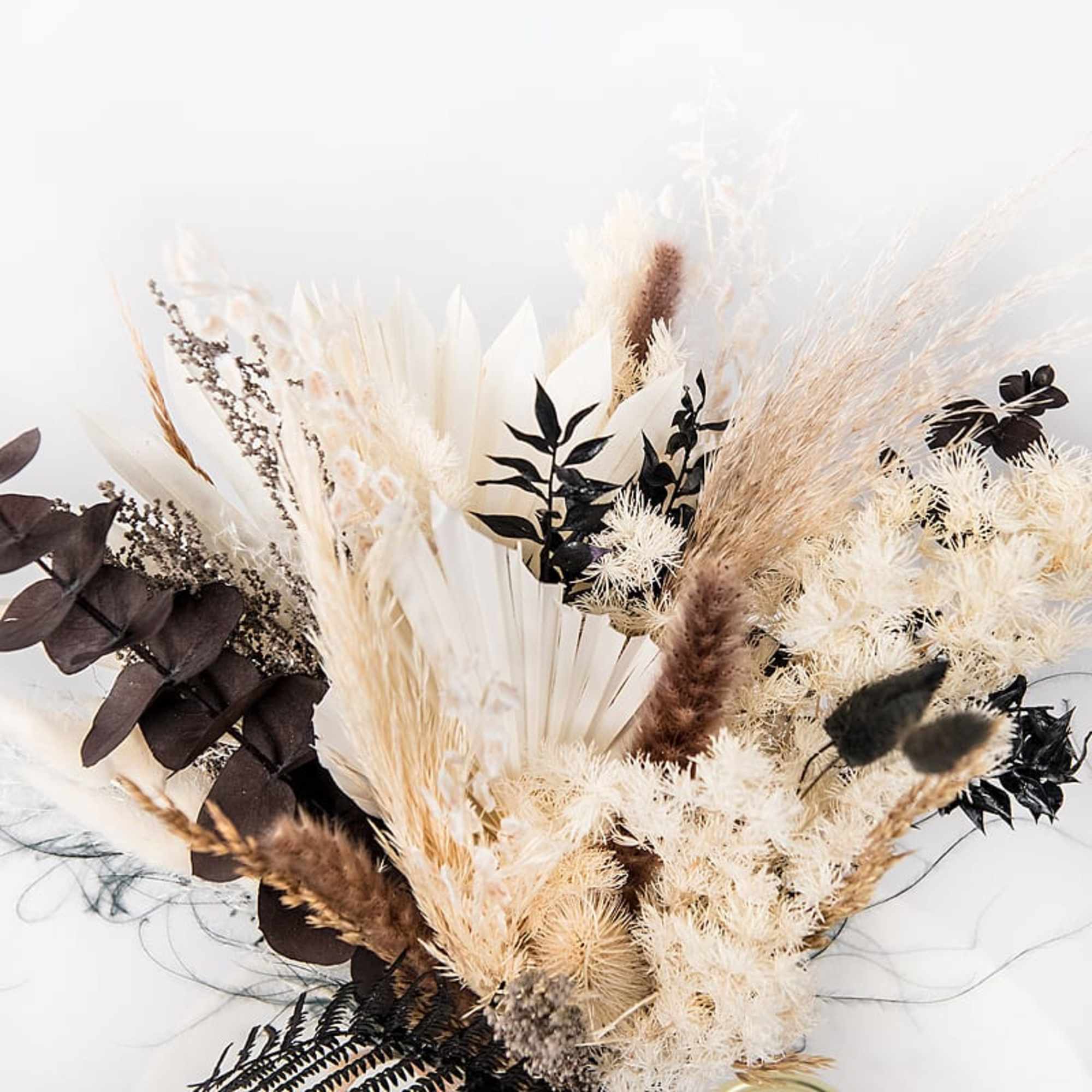 Dried floral arrangement with cream, tan, and dark brown textures