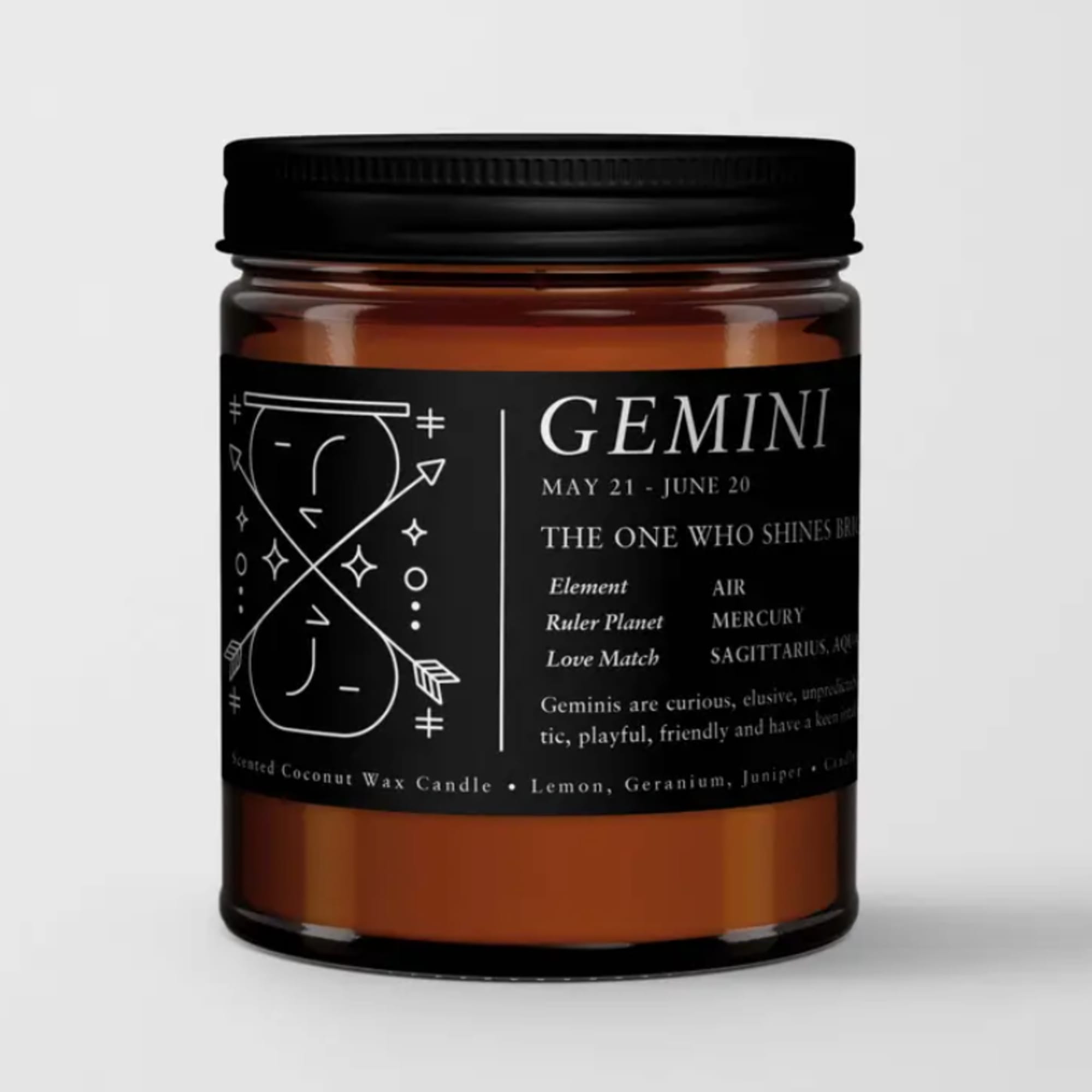 Amber candle in a black-labeled jar with Gemini text