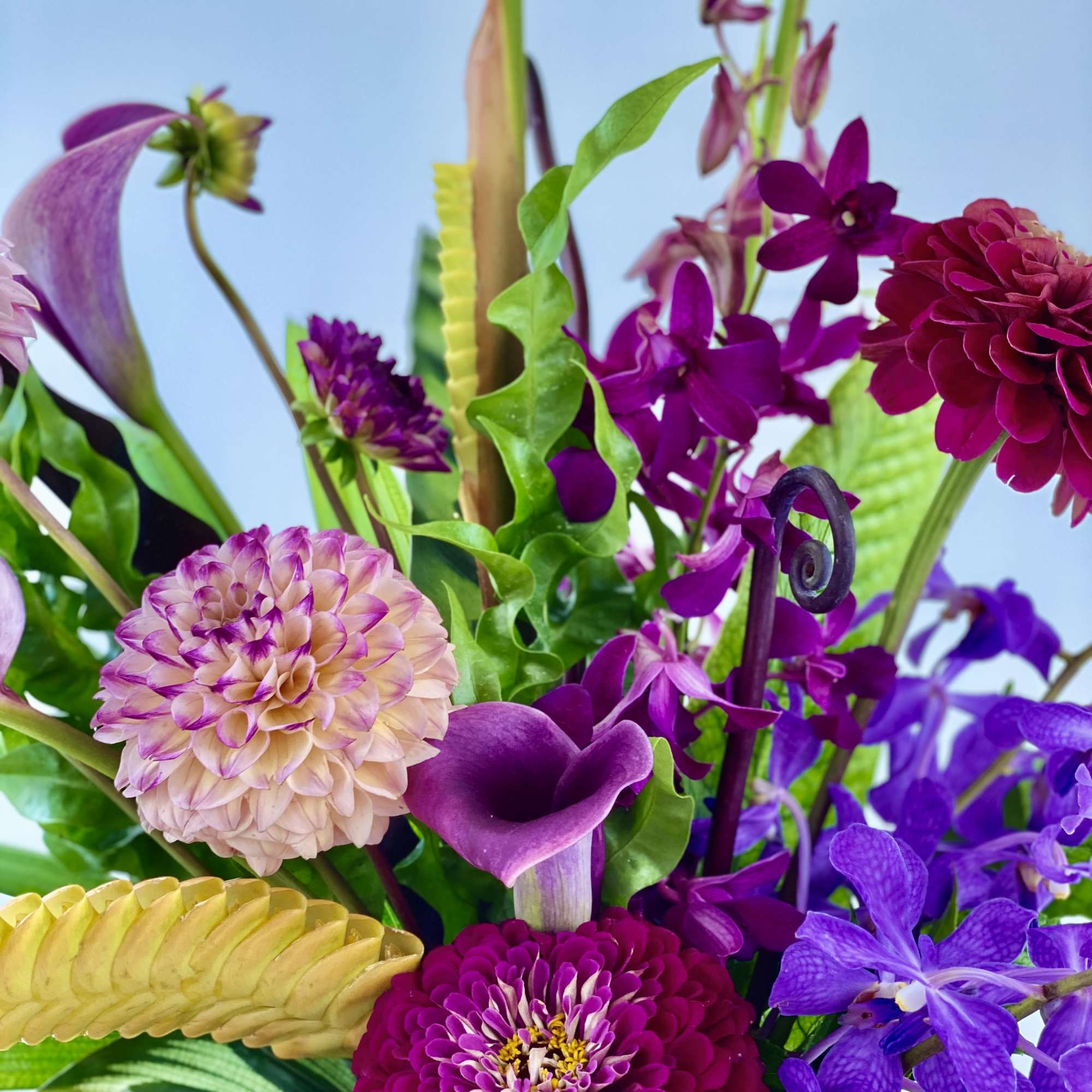 Purple and pink mixed bouquet with calla lilies, dahlias, and orchids