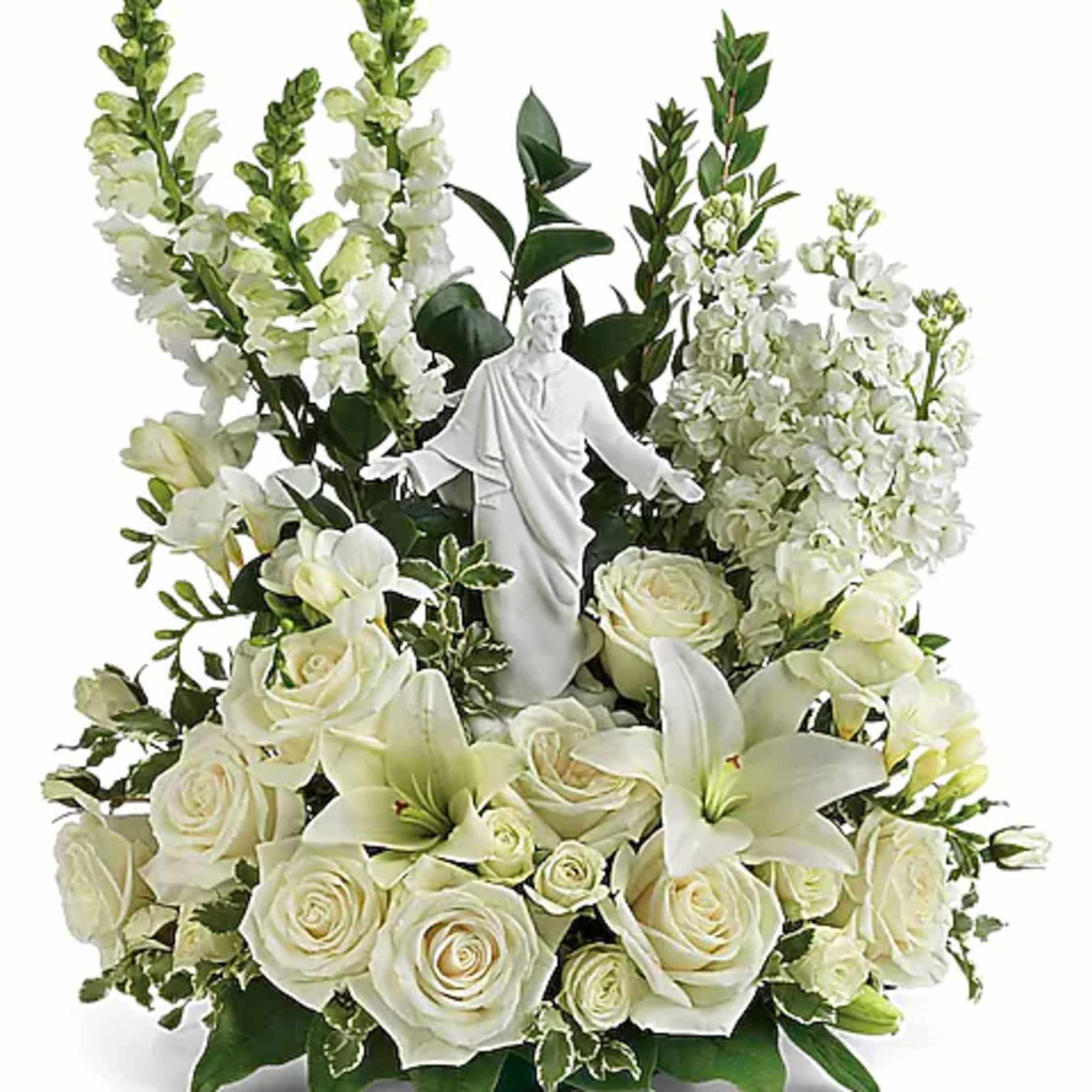 White roses and lilies arranged around a small white statue