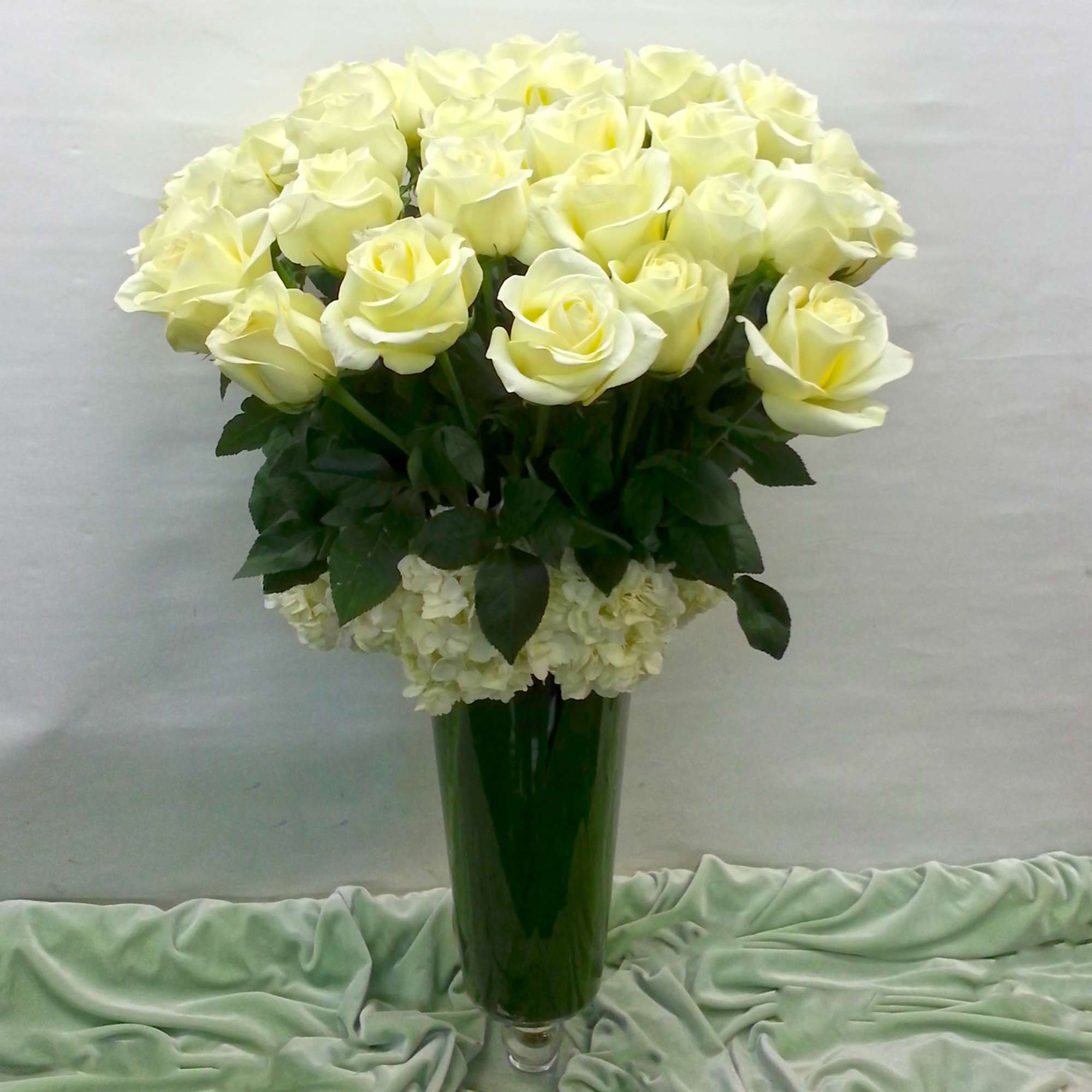 Bouquet of pale yellow roses in a tall green vase, photo 5 of 5