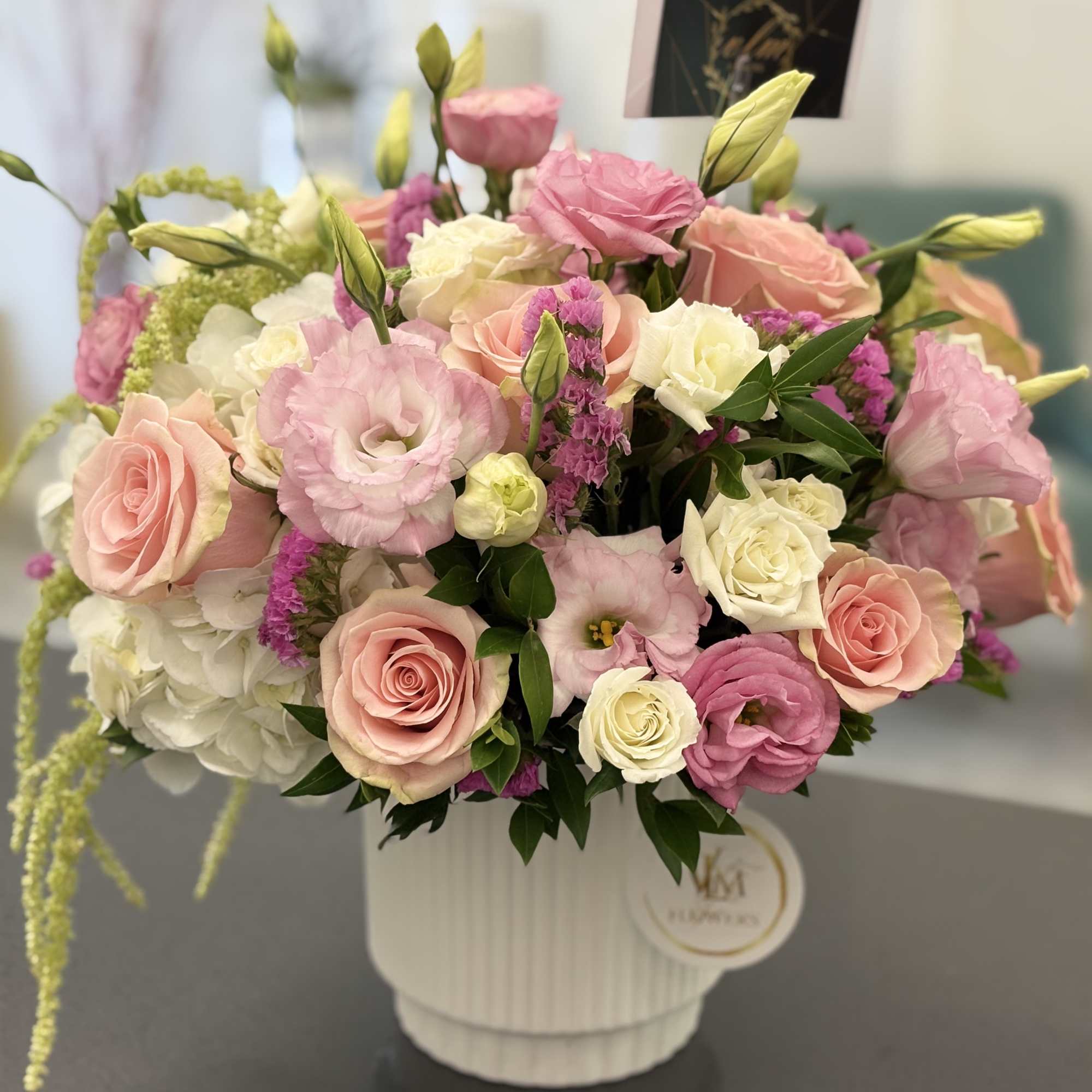 Pink and white mixed flower arrangement in a white vase