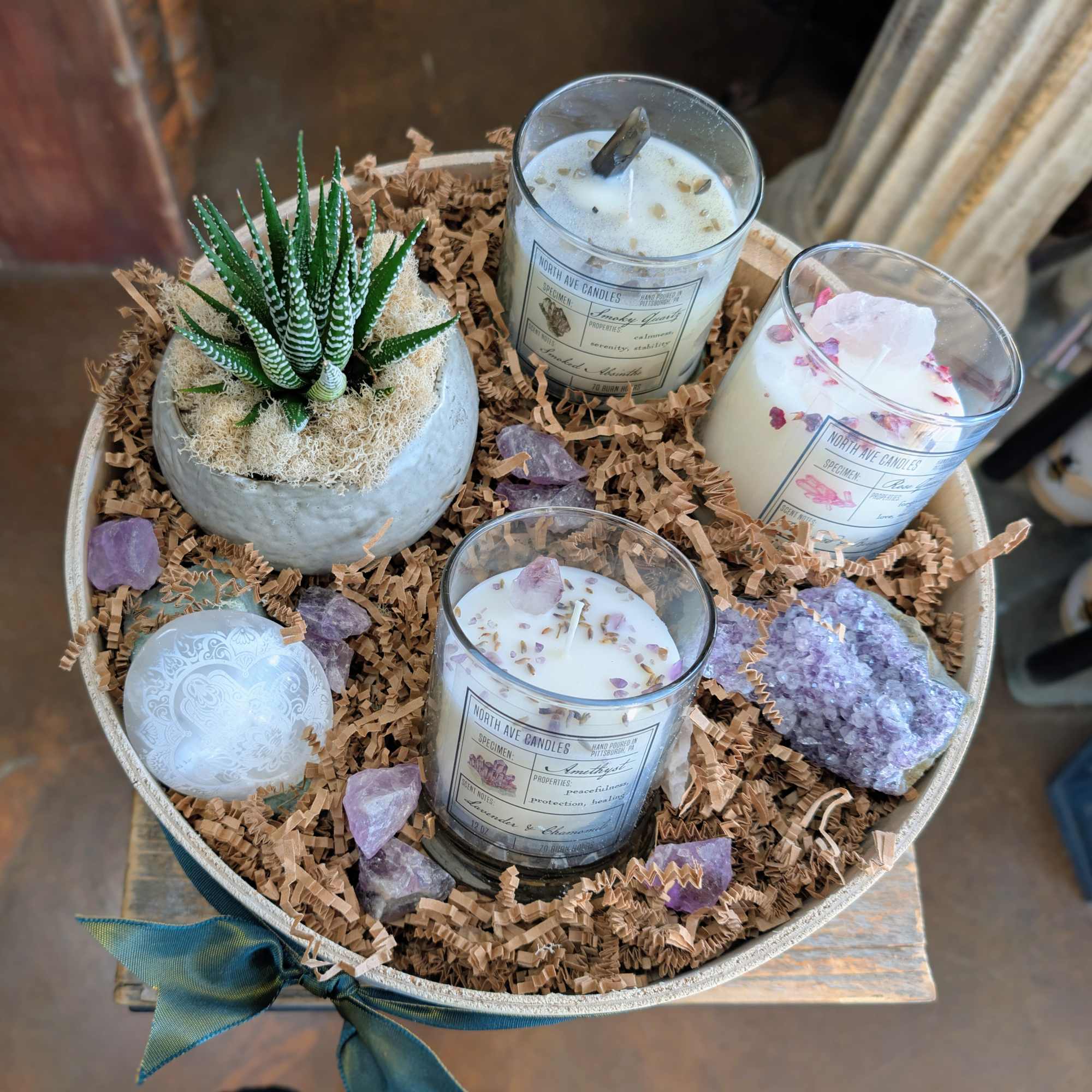 Gift tray with candles, a potted succulent, and crystals