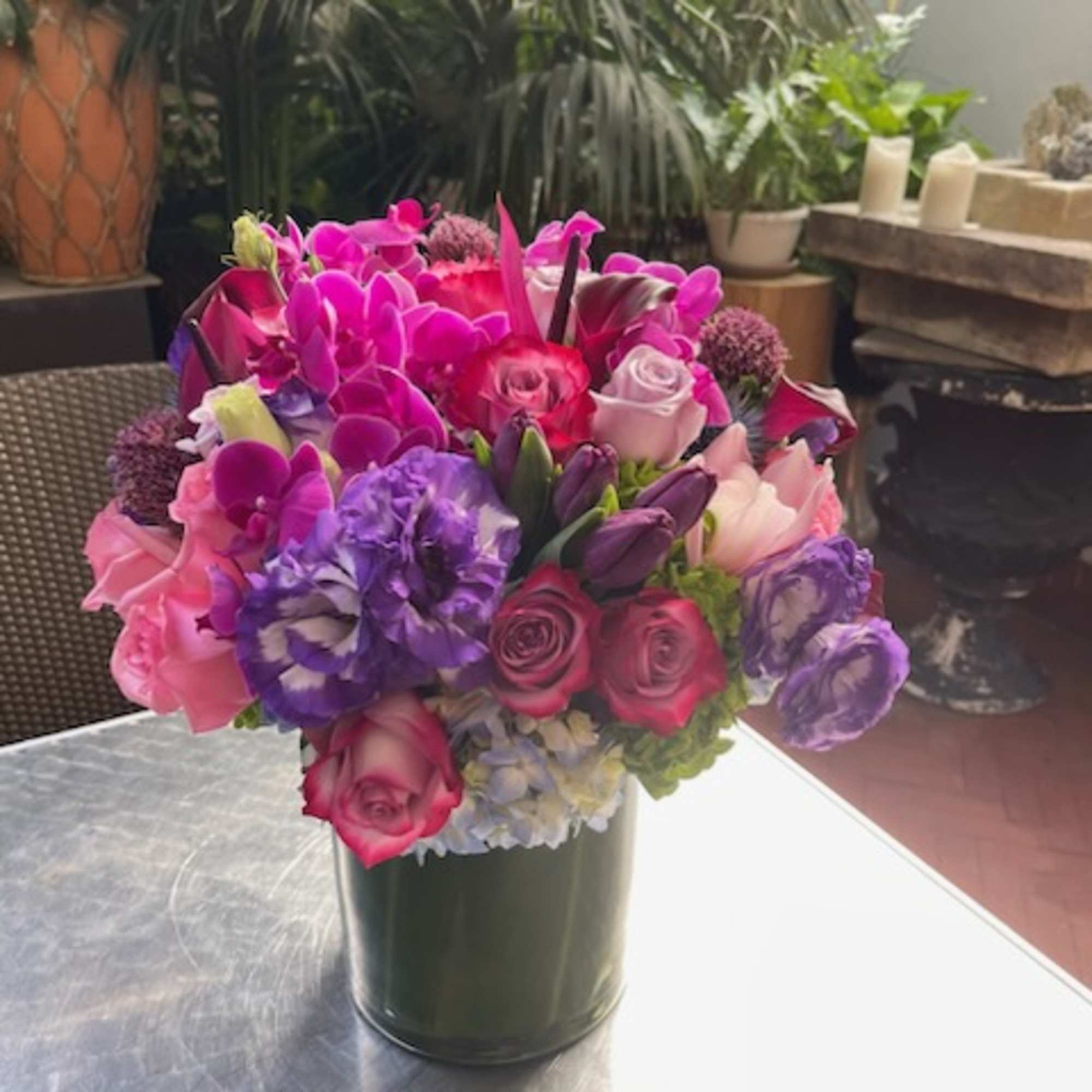 Bright pink and purple bouquet in a dark vase