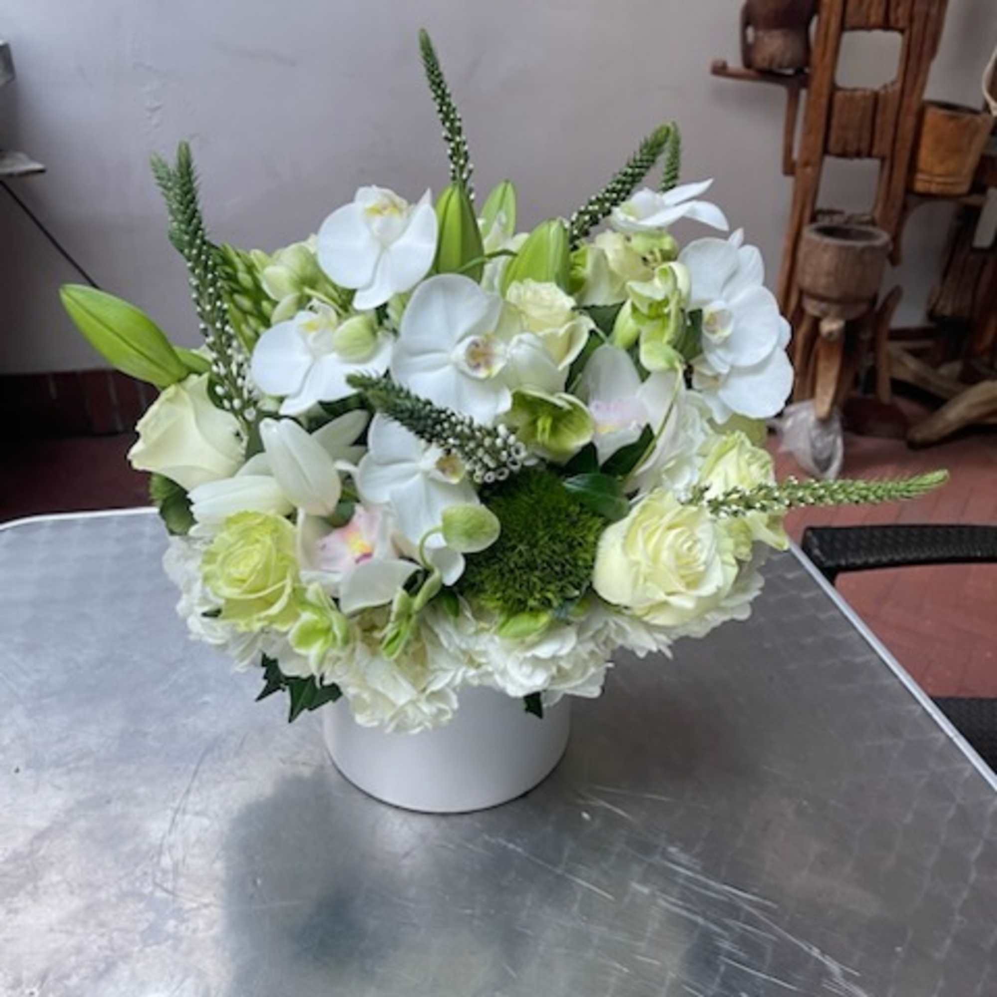 White floral arrangement in a round white vase