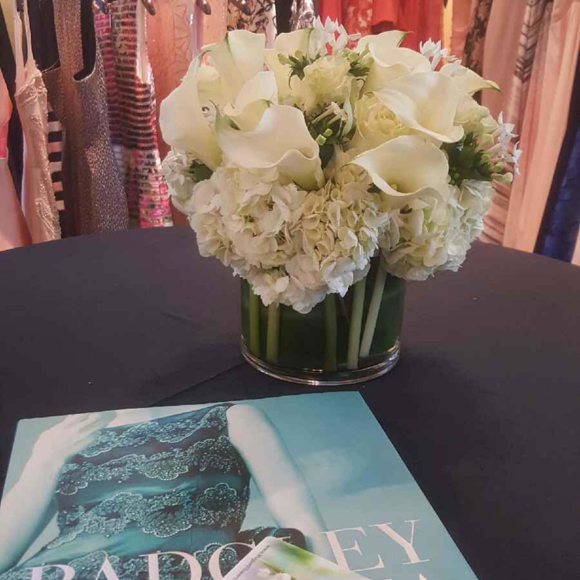 White floral arrangement in a glass vase on a table