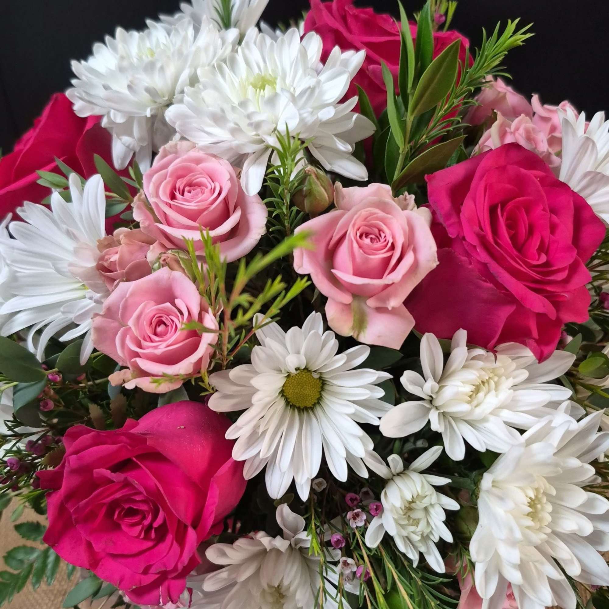 Hot pink roses, spray roses, and white daisies in a pink vase, photo 3 of 3