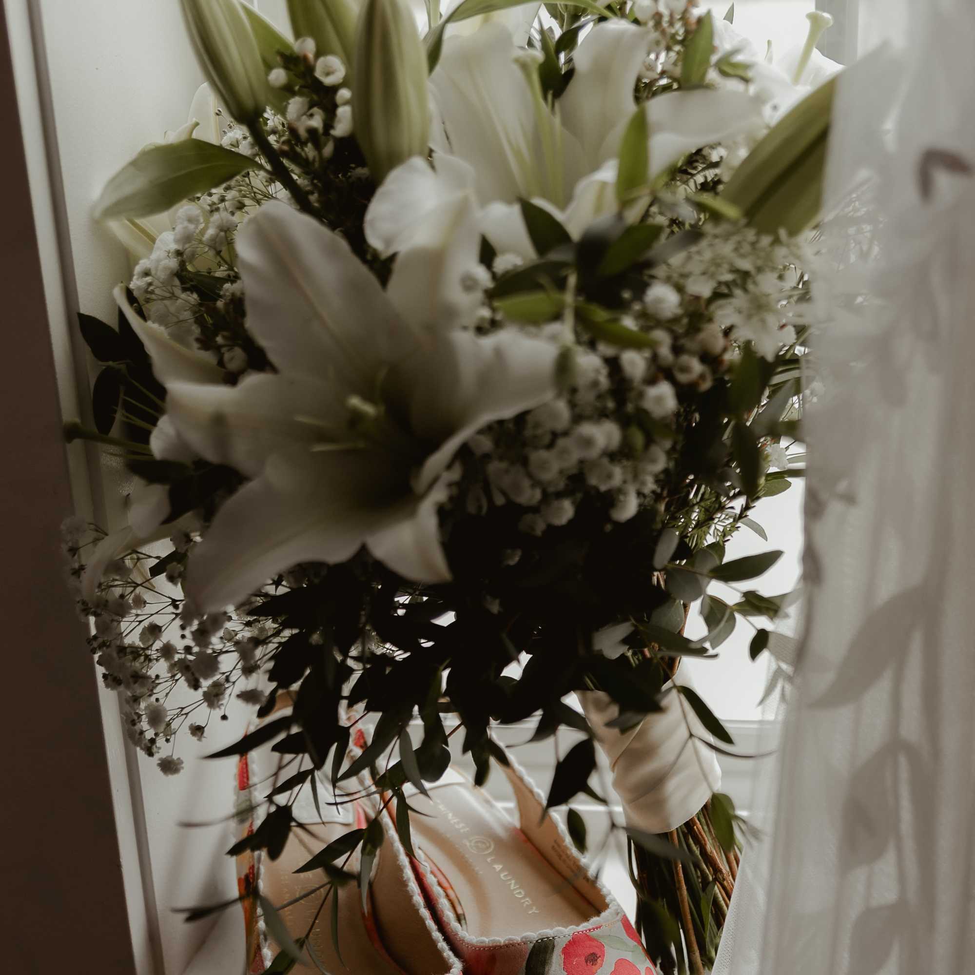 Simple and elegant bouquet of lilies, waxflower, and baby's breath , photo 2 of 3
