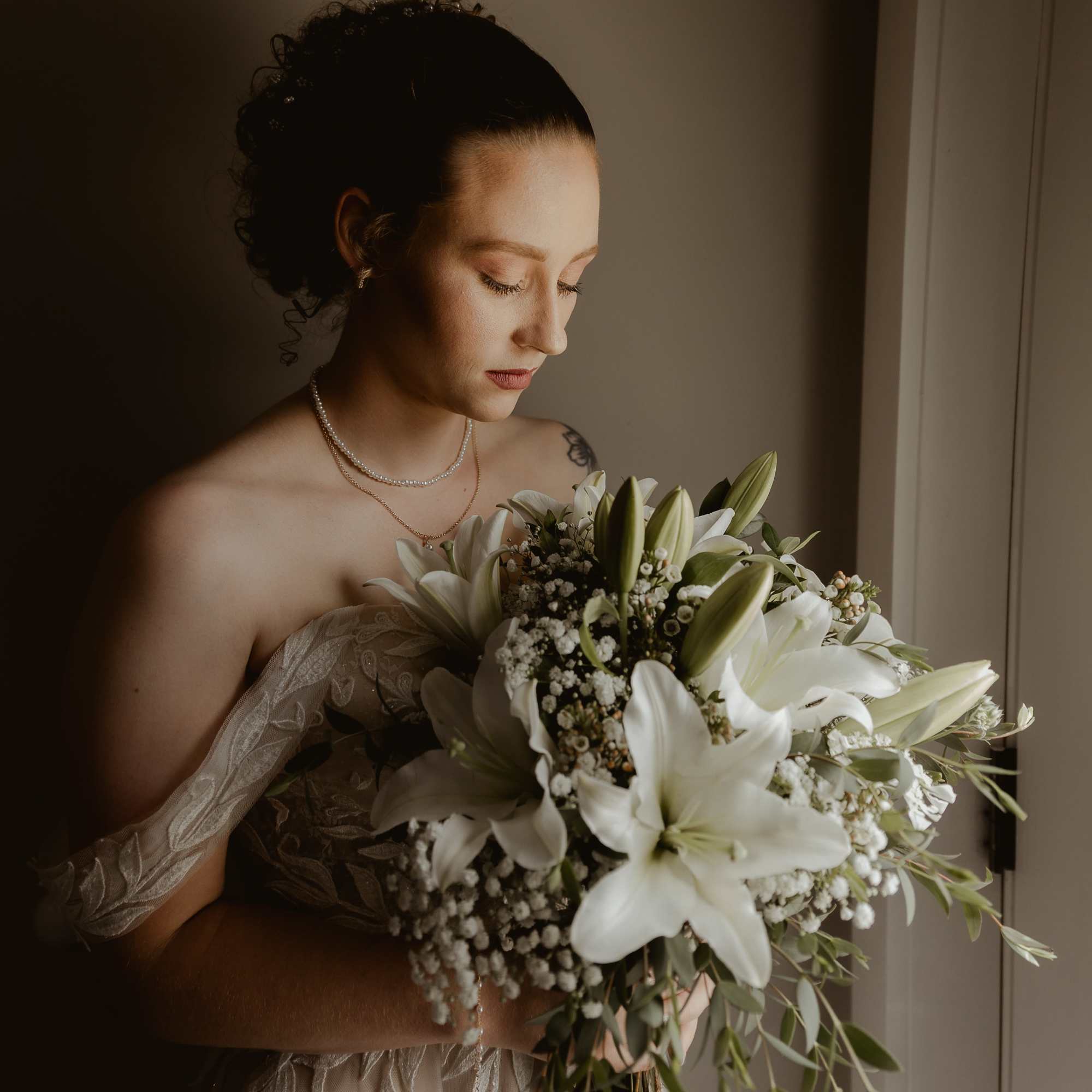 Simple and elegant bouquet of lilies, waxflower, and baby's breath 