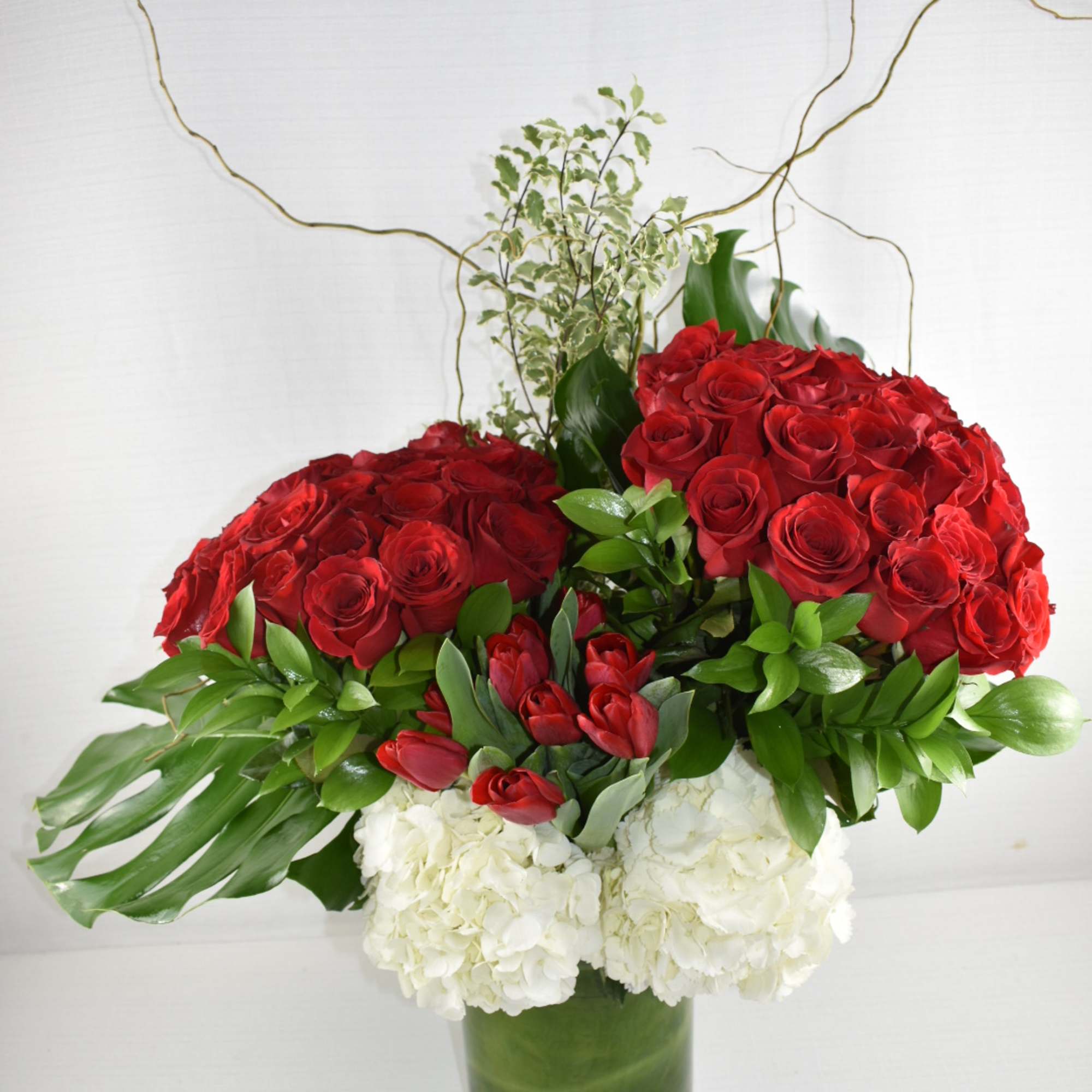 This grand Sebas flowers custom design 
was created in a cylinder vase, photo 2 of 3