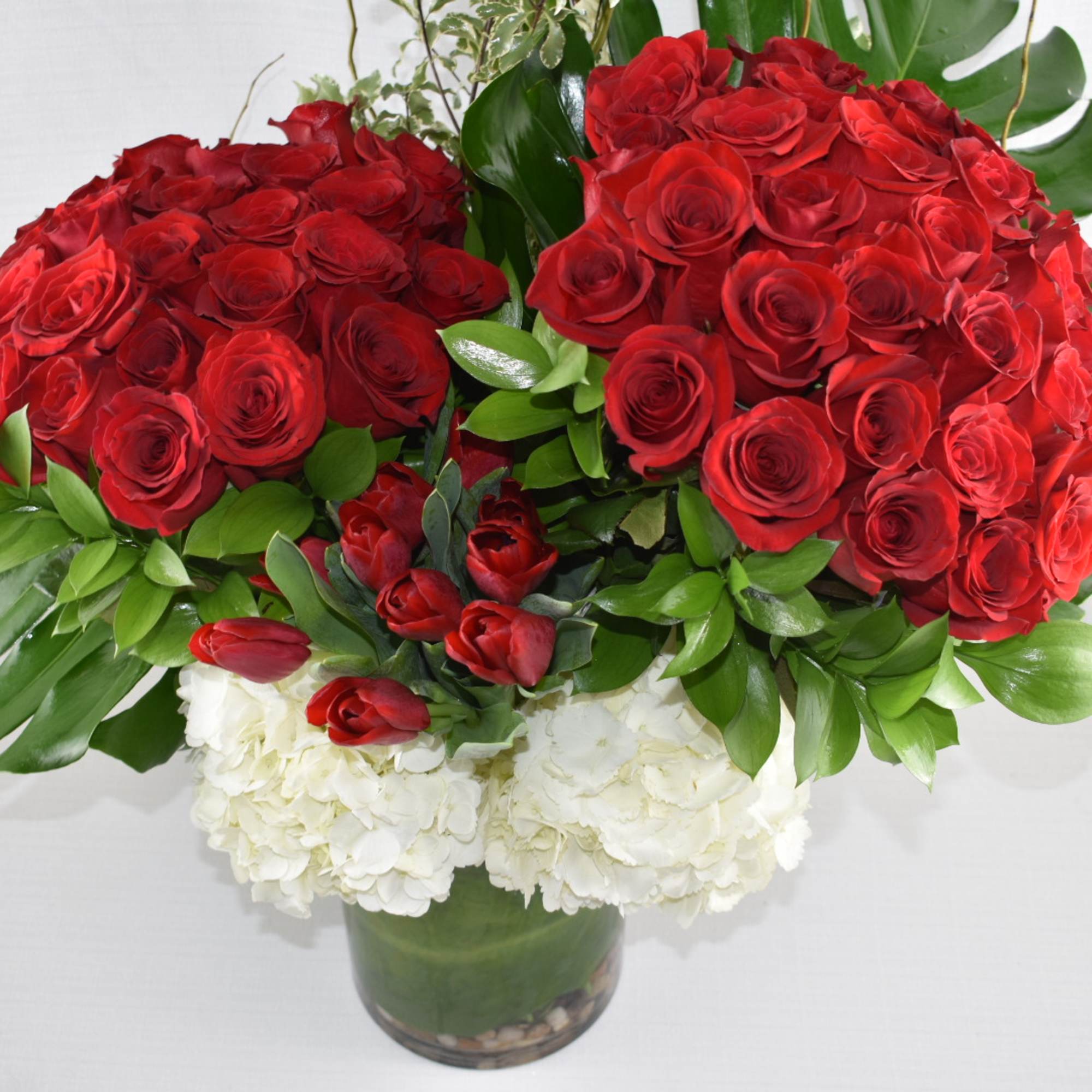 This grand Sebas flowers custom design 
was created in a cylinder vase, photo 3 of 3