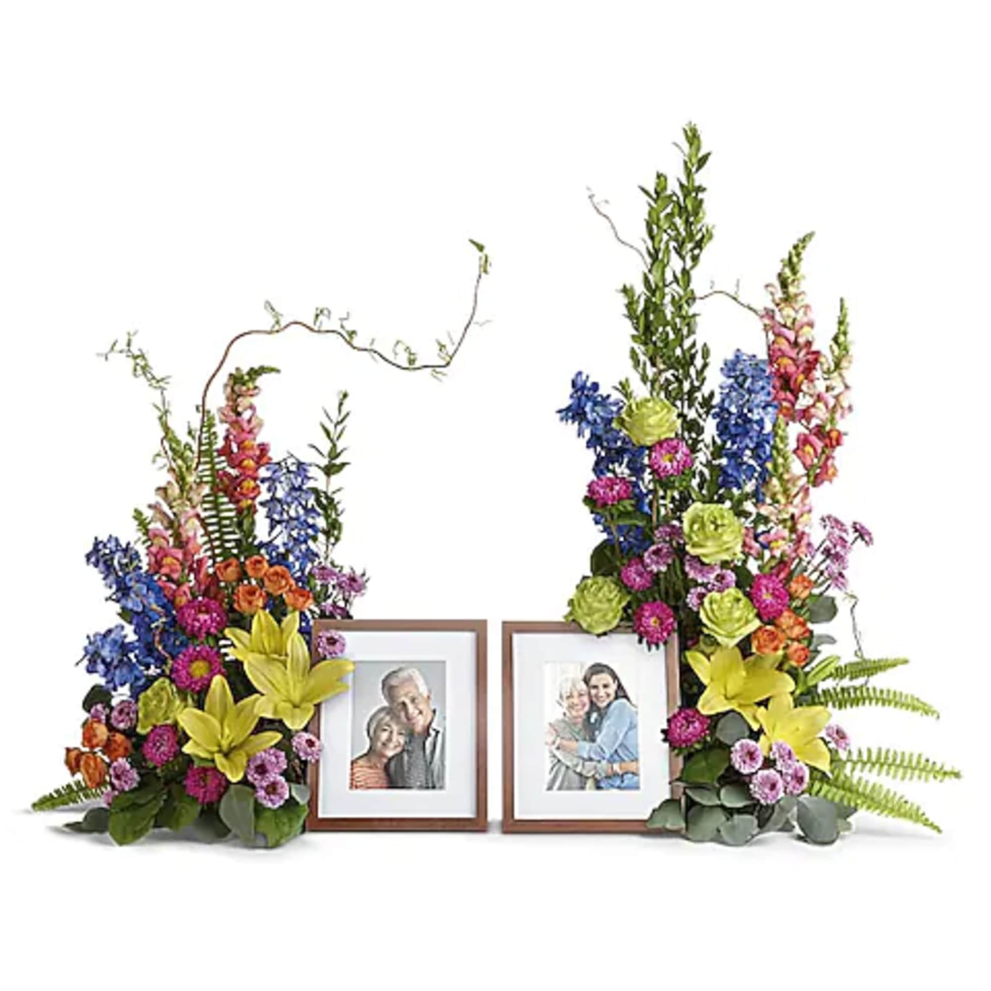 Two colorful floral photo frame arrangements with framed pictures in the center