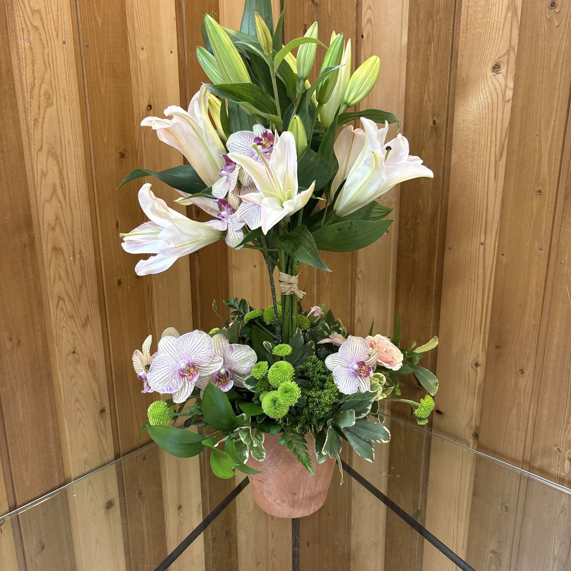  Bright  lilies are uniquely arranged into a topiary and grounded