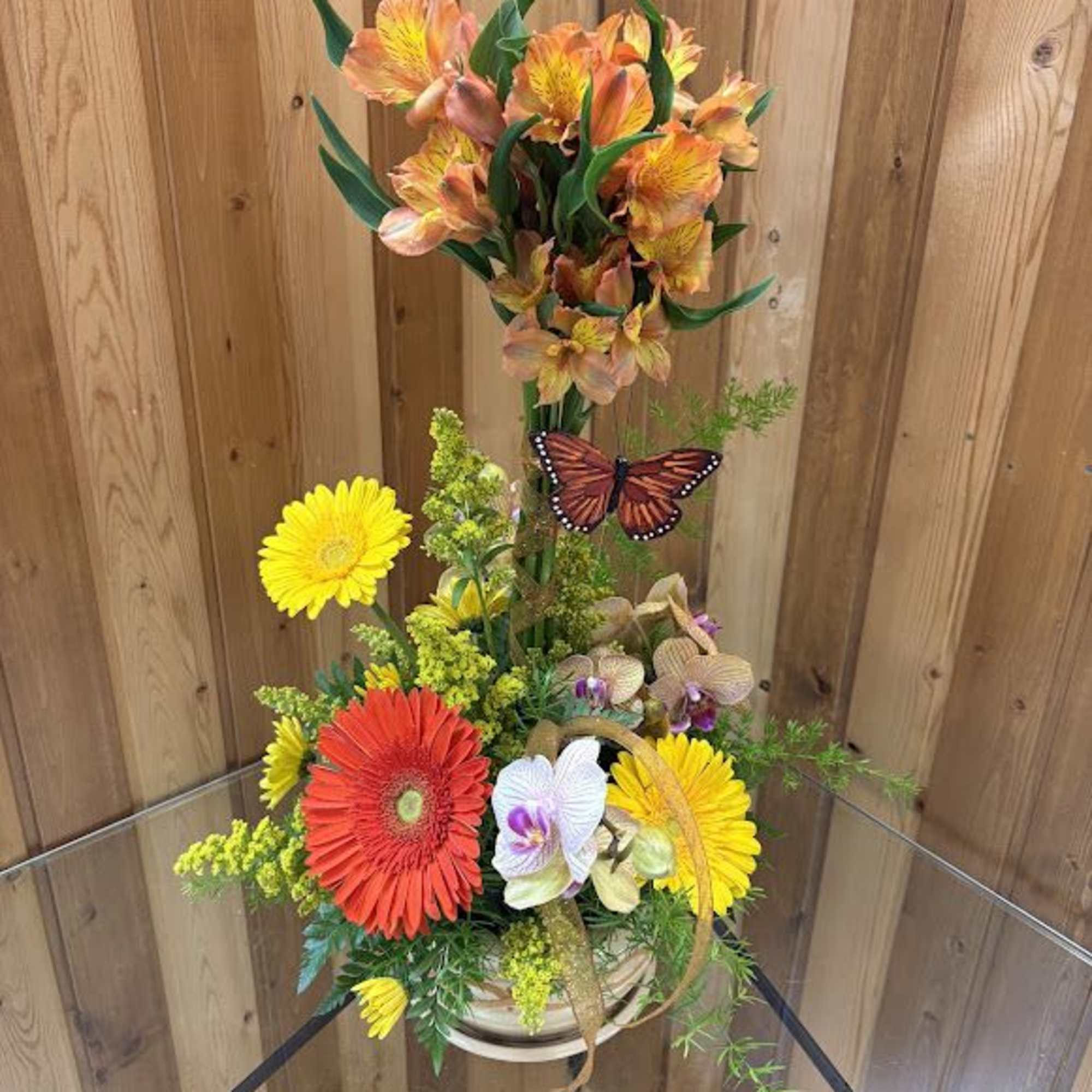  Bright  lilies are uniquely arranged into a topiary and grounded, photo 2 of 2