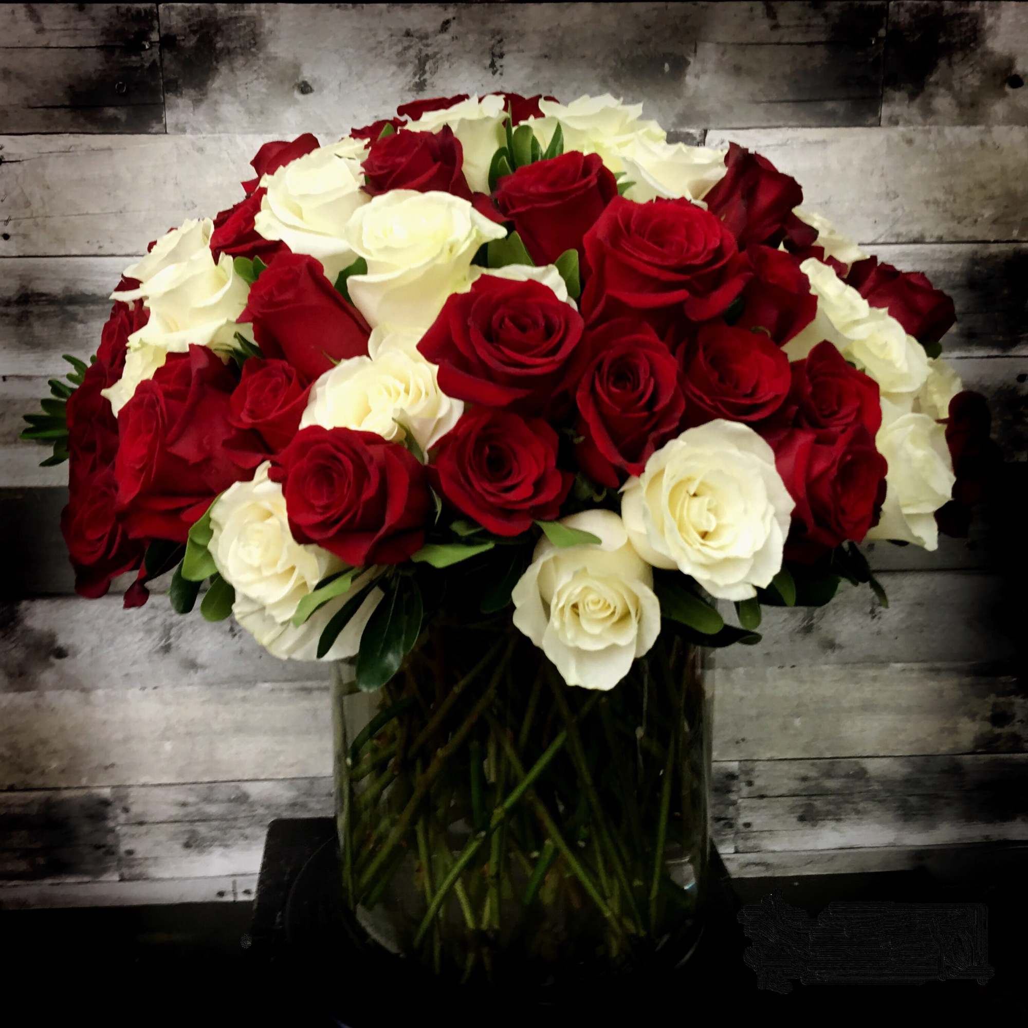 Bouquet of red and white roses in a glass vase