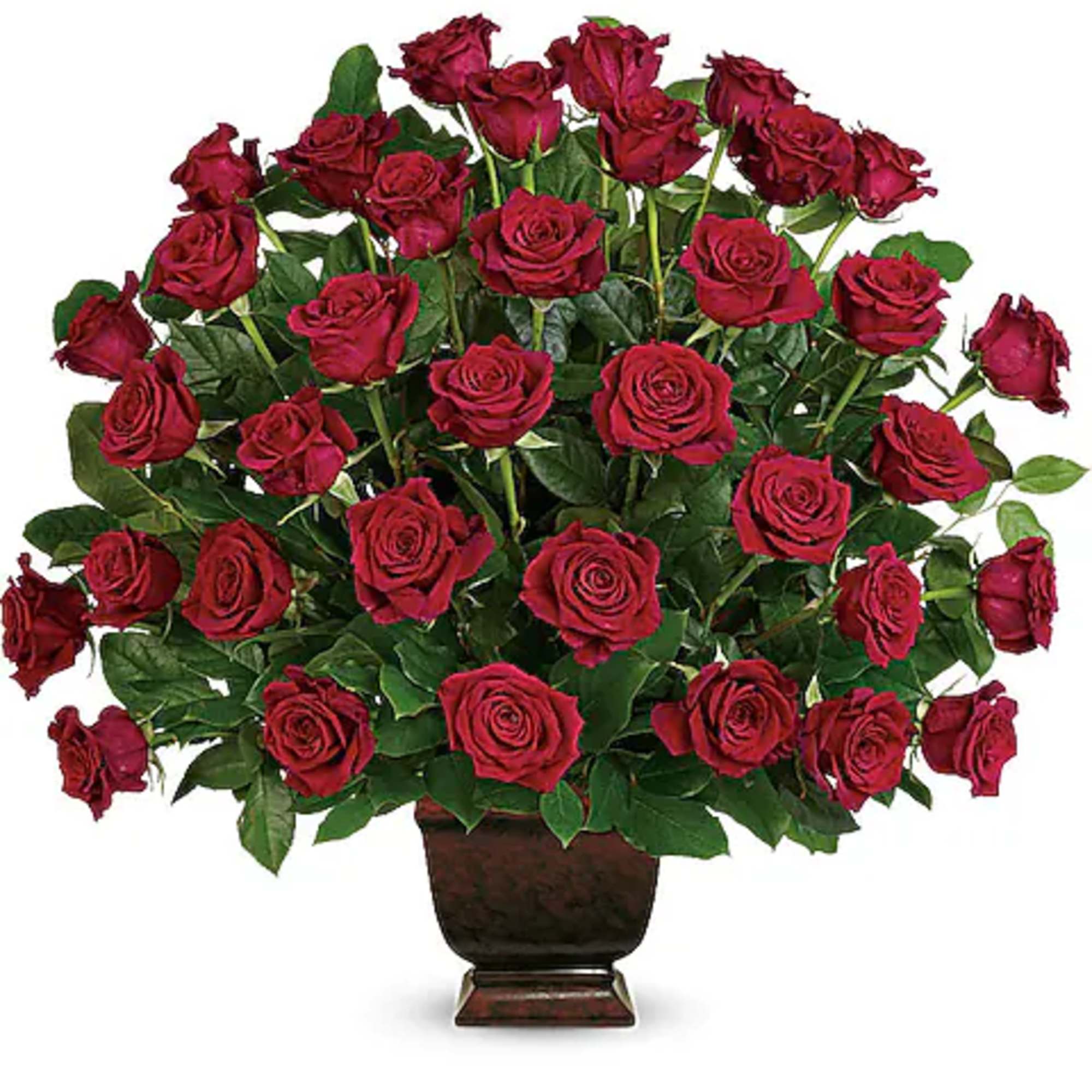 Bouquet of red roses in a dark pedestal vase