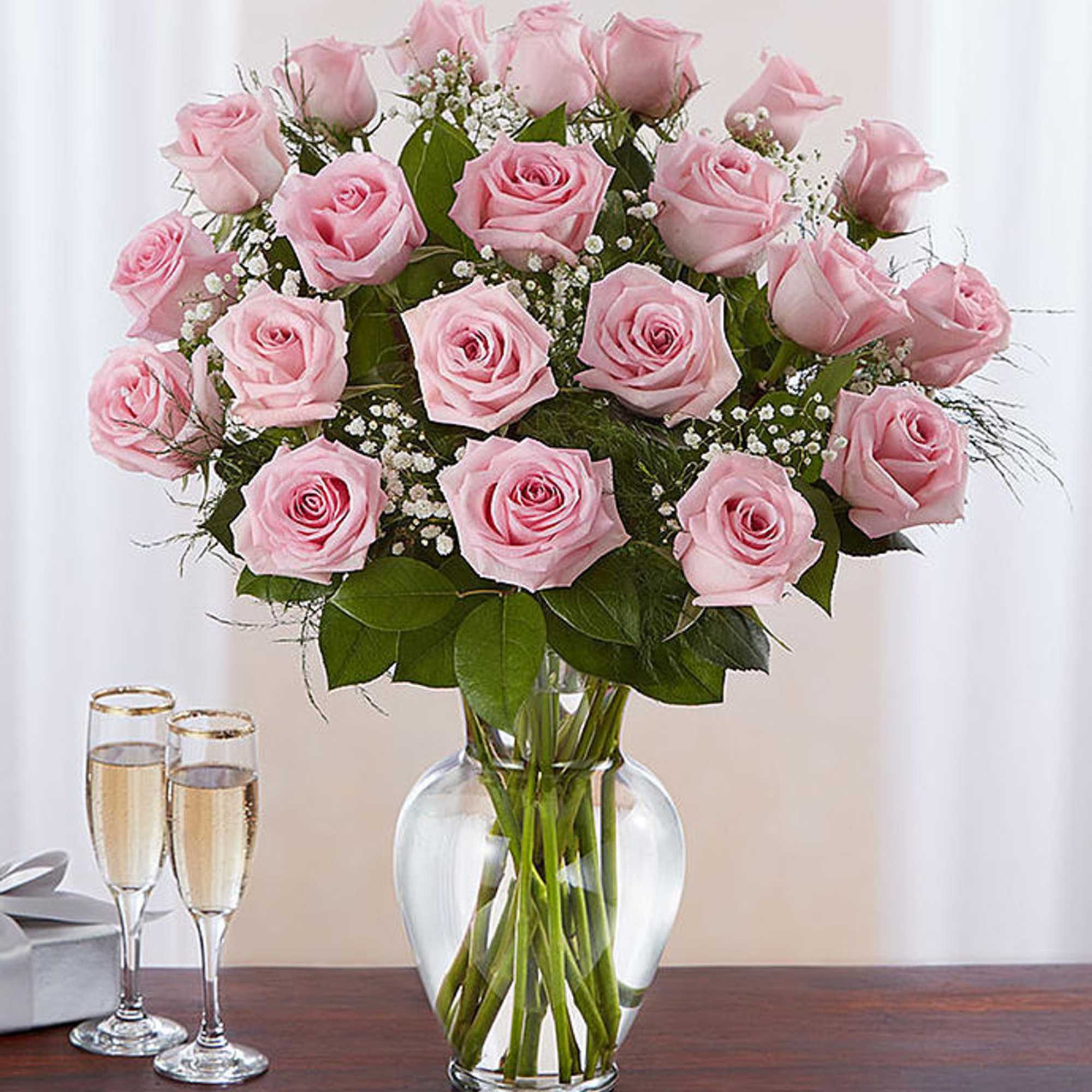 Pink roses arranged in a clear glass vase