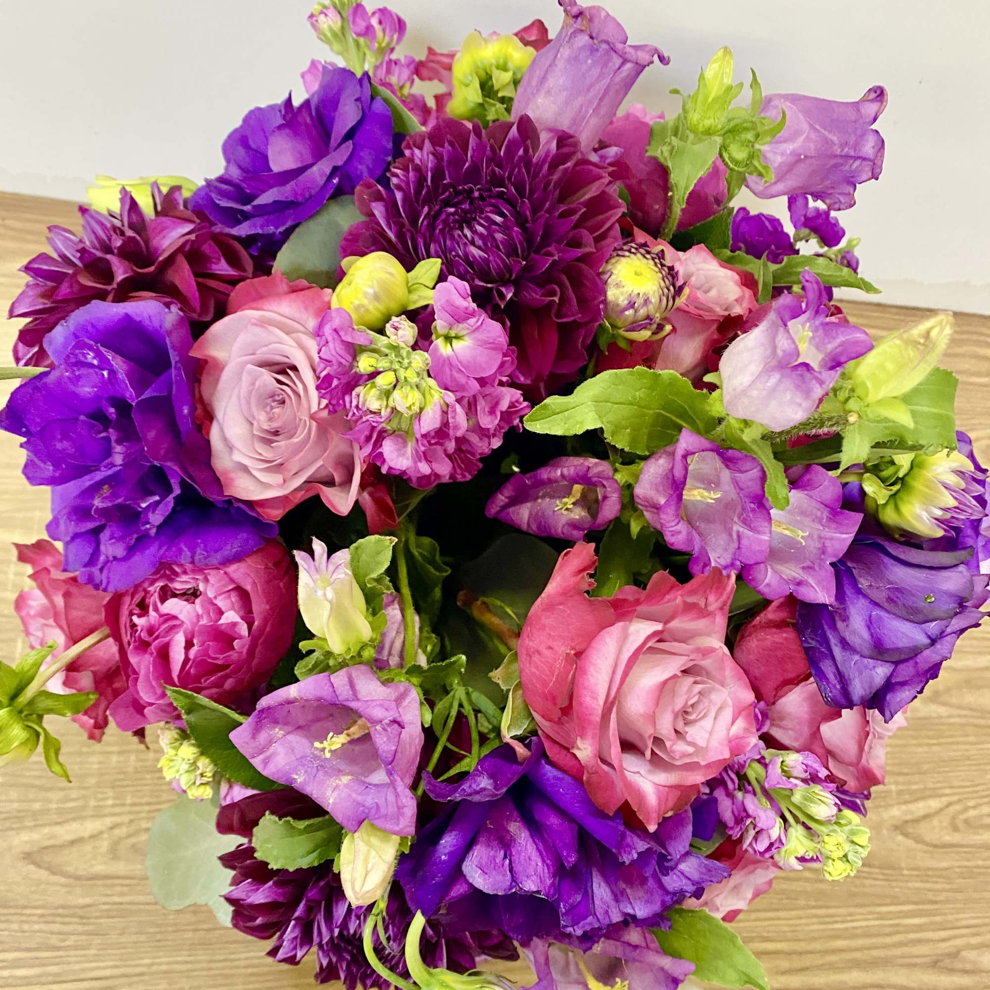 Clear glass vase with a purple lisianthus, purple roses ,lavender stock , photo 2 of 3