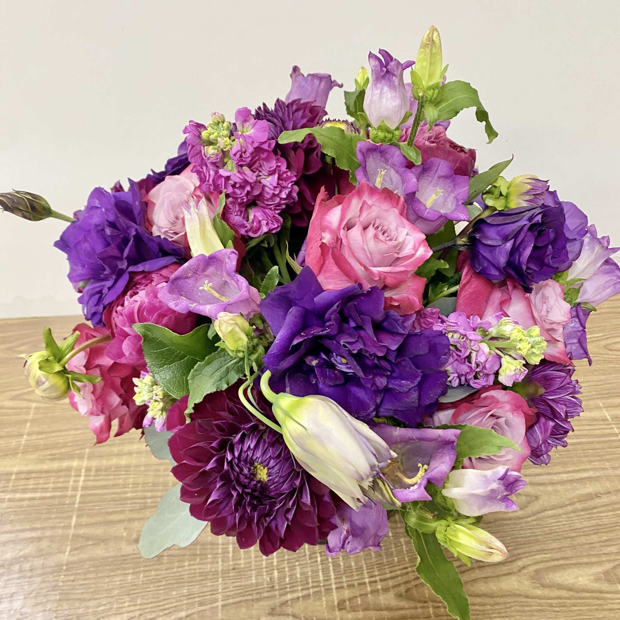 Clear glass vase with a purple lisianthus, purple roses ,lavender stock , photo 3 of 3