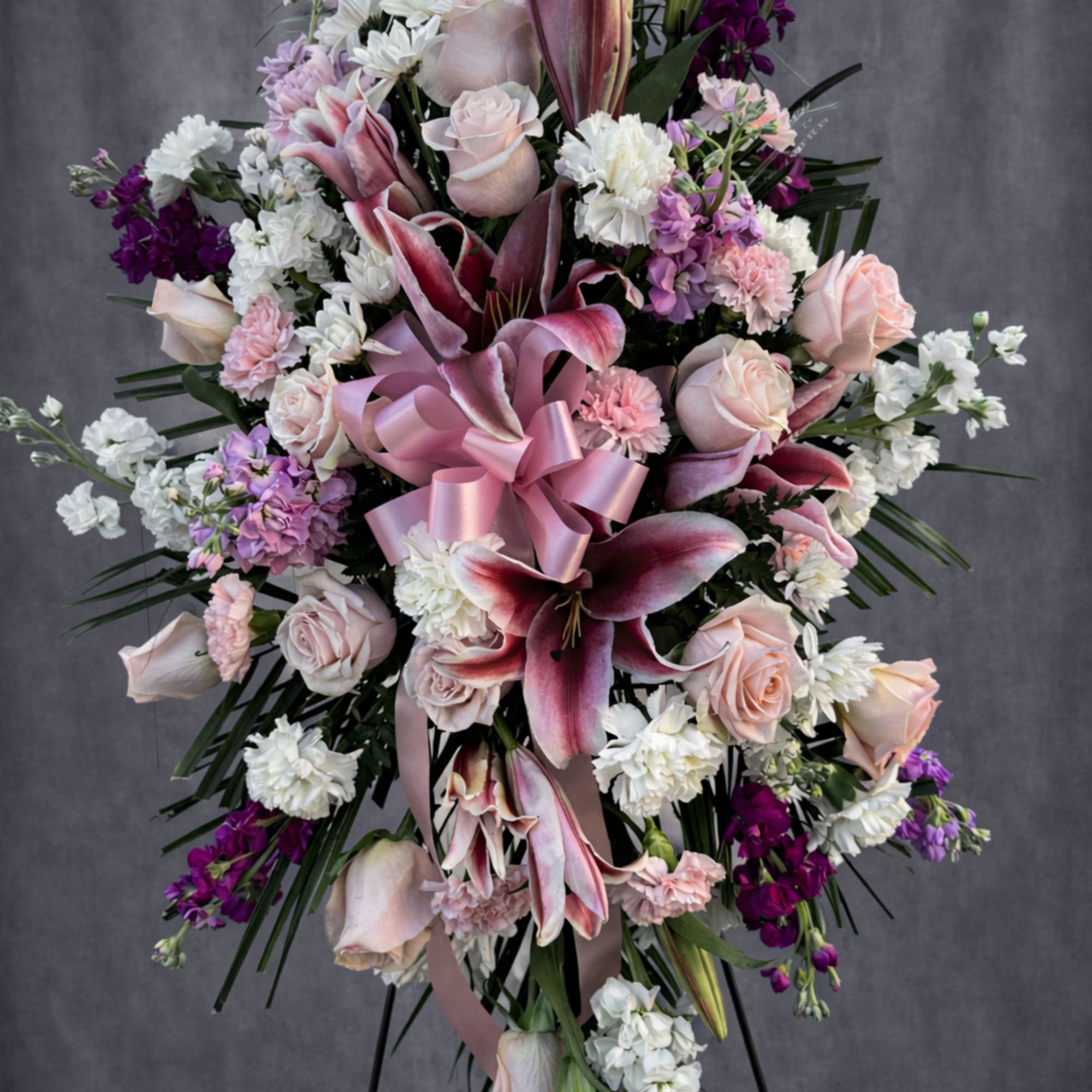 The soft blush roses, stargazer lilies, and layers of pinks, whites, and
