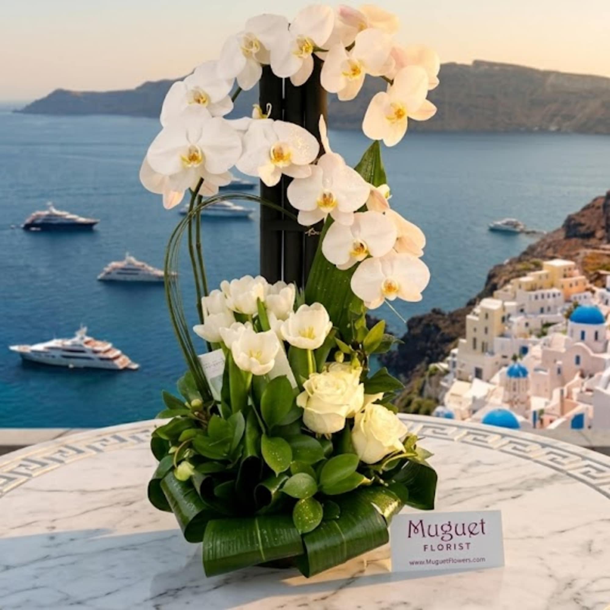 Tall white orchid arrangement with roses in a black container