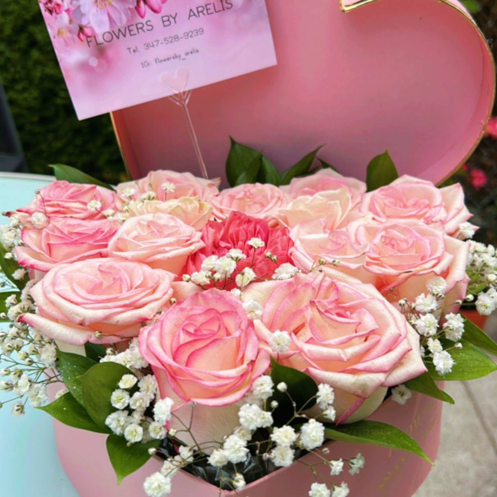 Pink roses in a heart-shaped box with baby's breath
