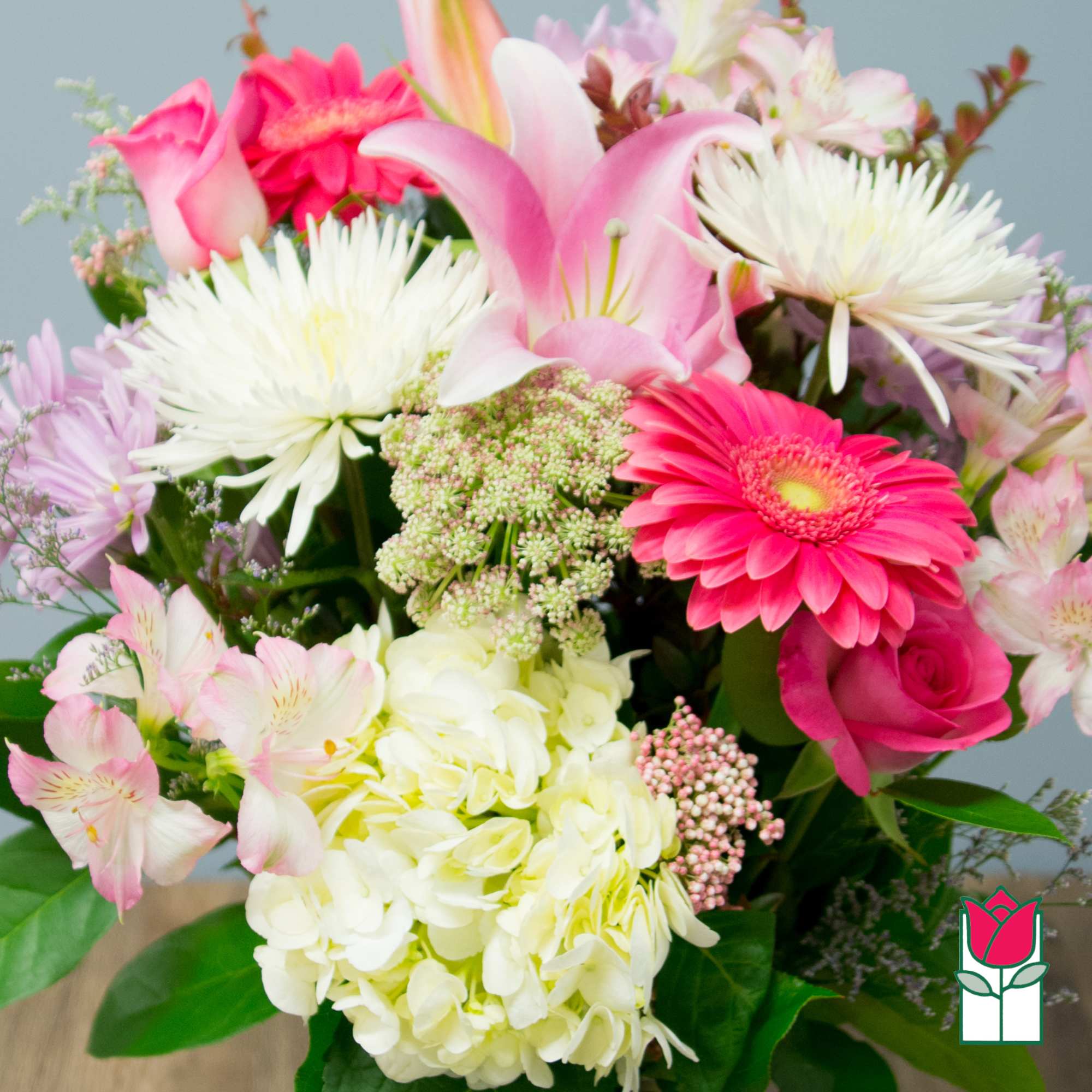 Mixed bouquet with pink lilies, gerbera daisies, roses, and white hydrangeas