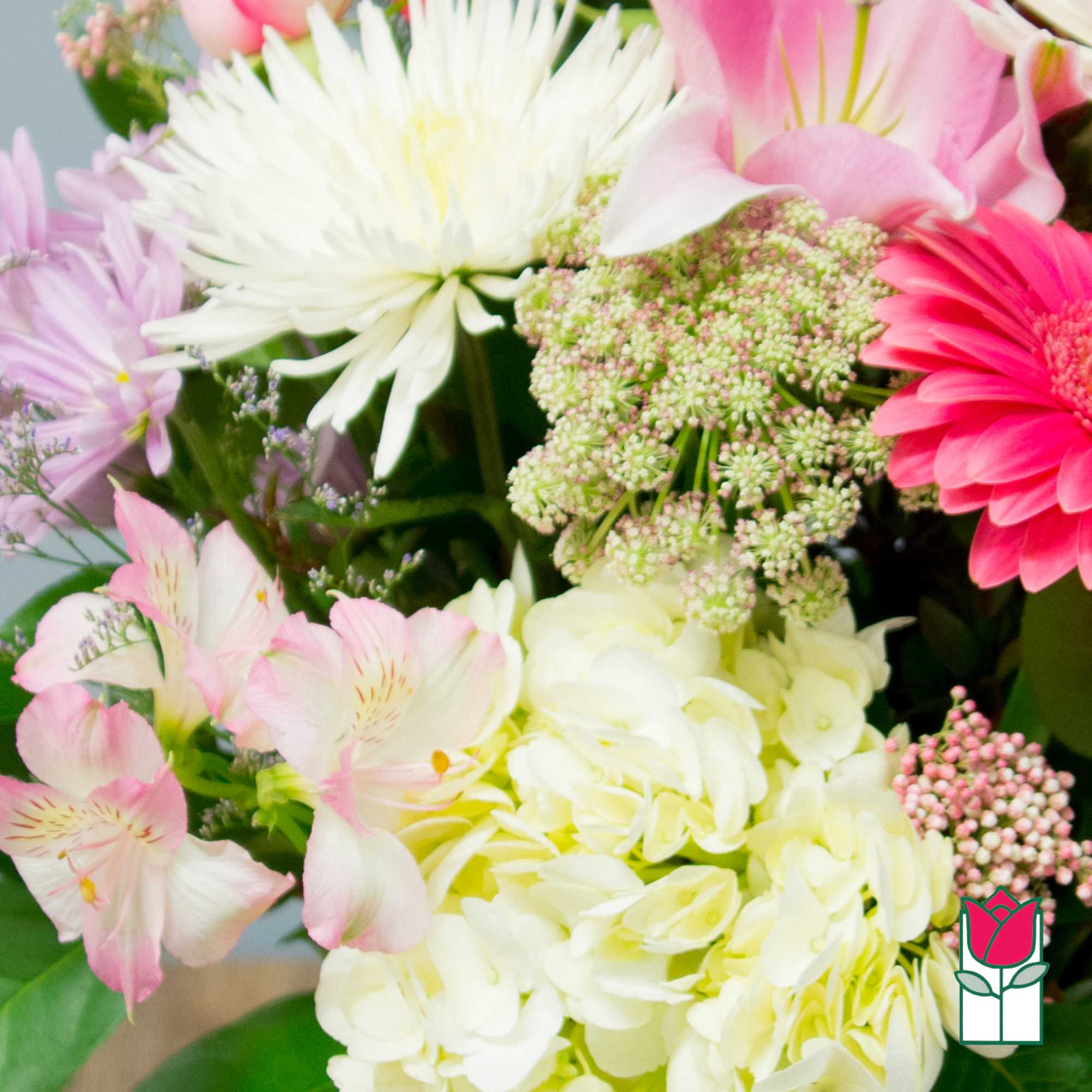 Mixed bouquet with pink lilies, white chrysanthemums, and pale hydrangeas