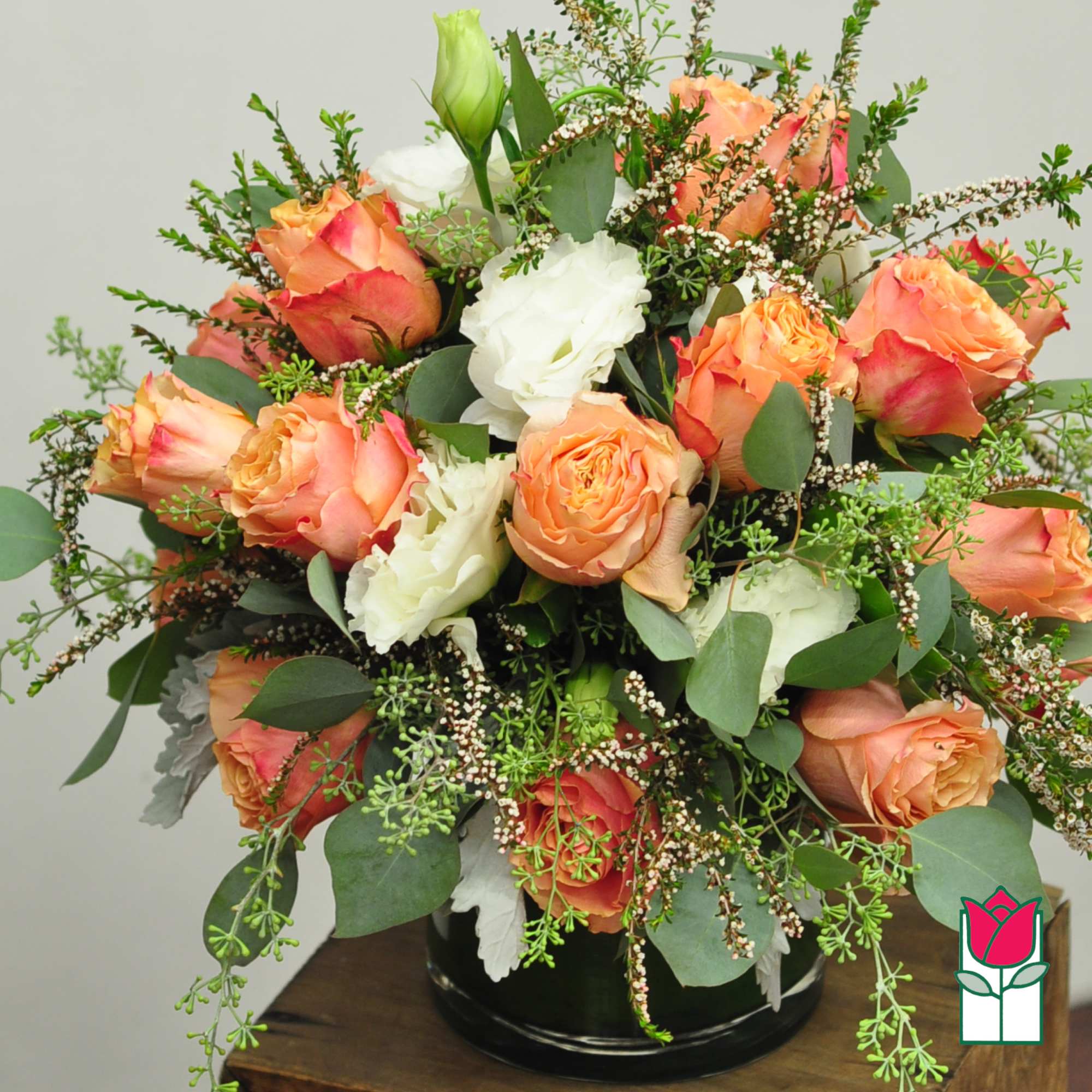 Bouquet of peach and white roses in a black vase