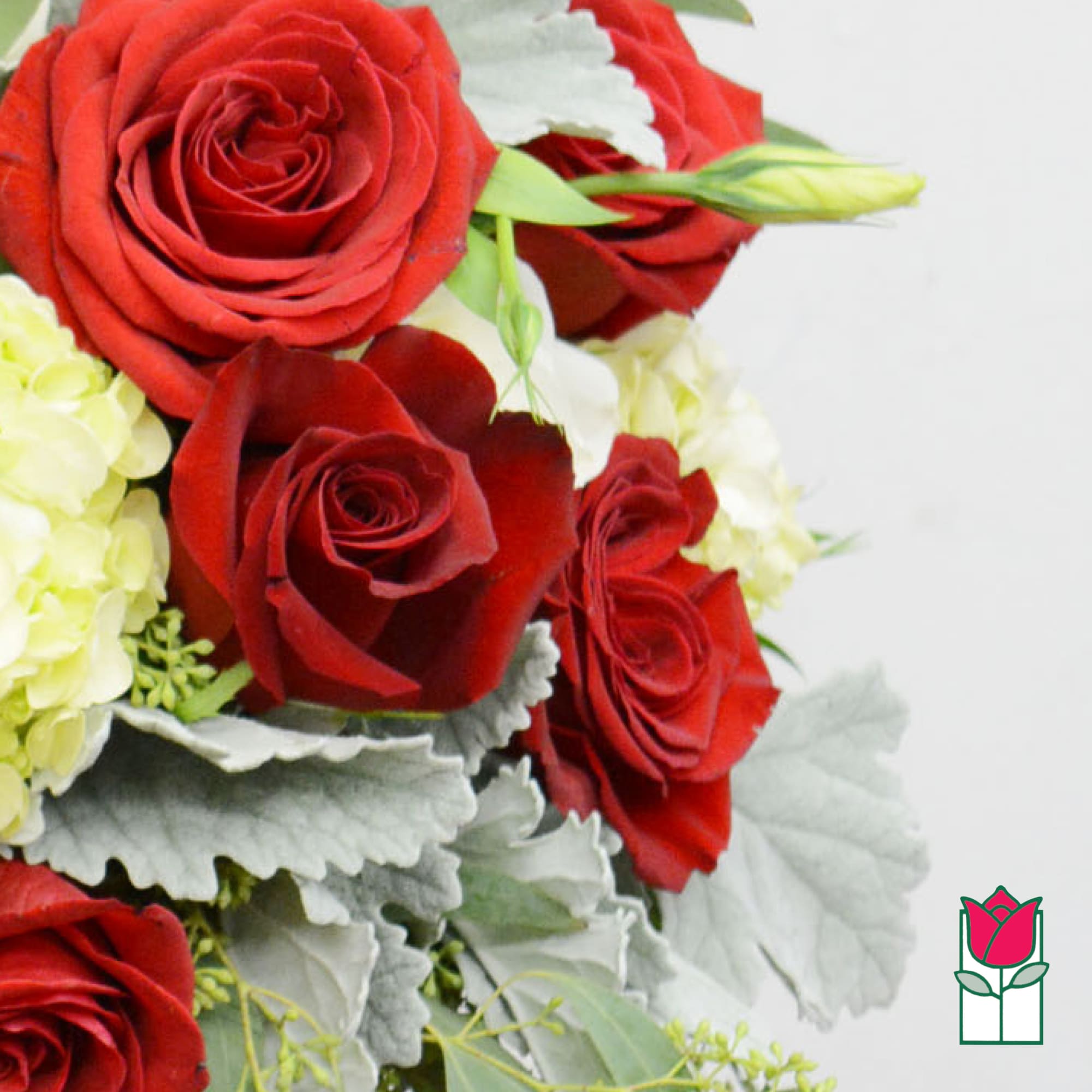 Bouquet of red roses with pale yellow flowers and silver foliage