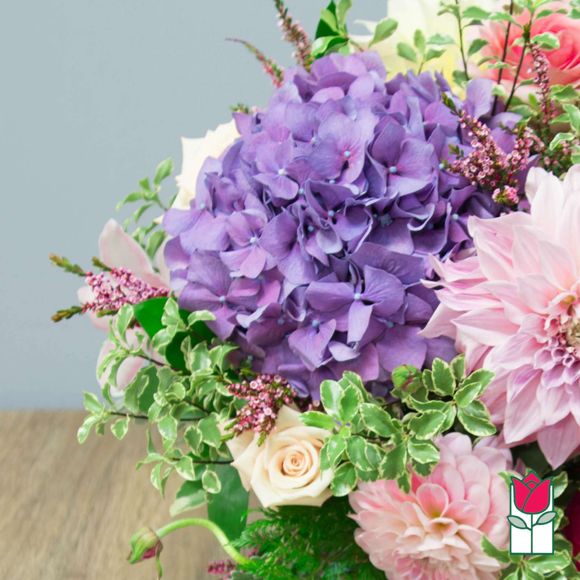 Bouquet with purple hydrangea, pink dahlia, and cream roses