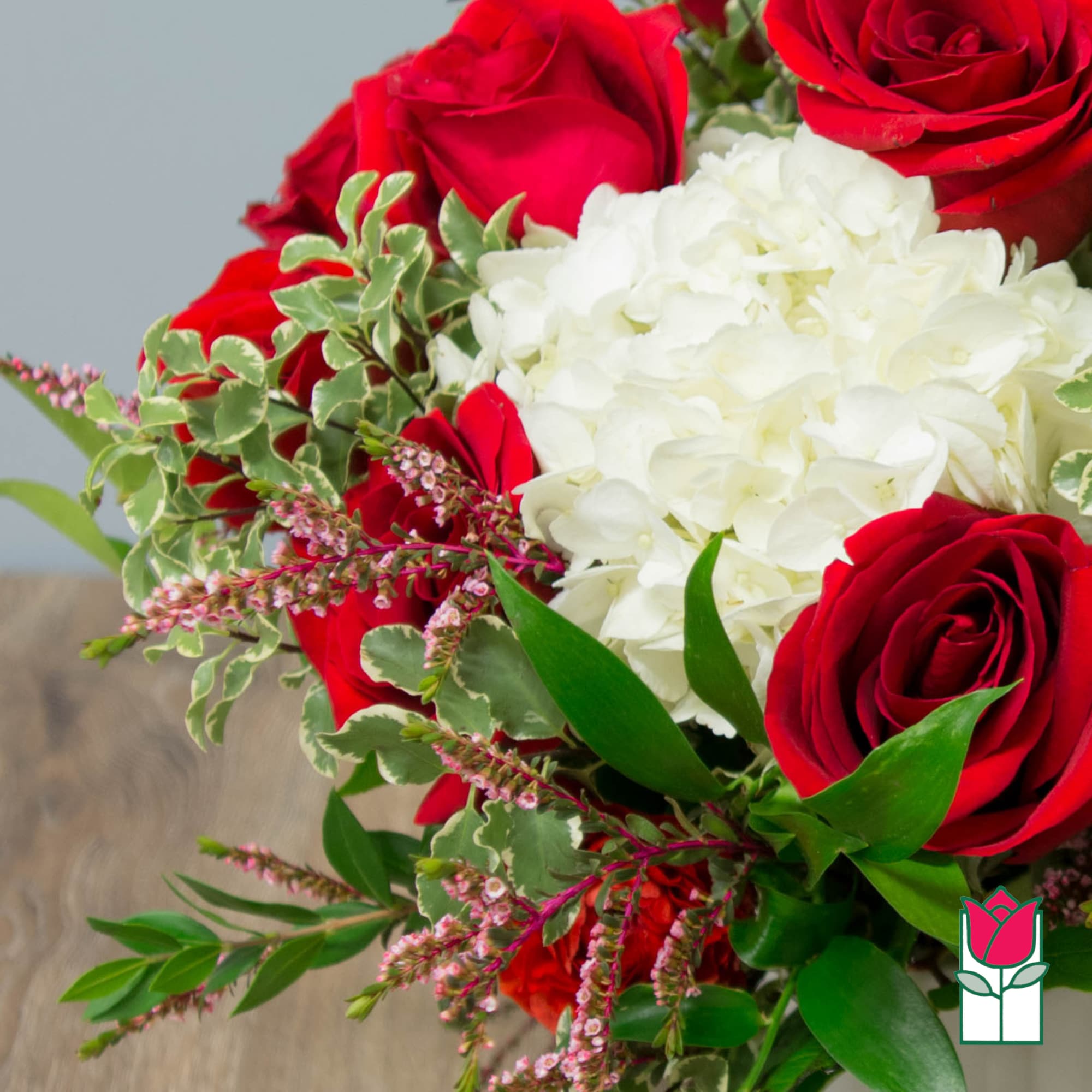 Bouquet of red roses and white hydrangeas with greenery