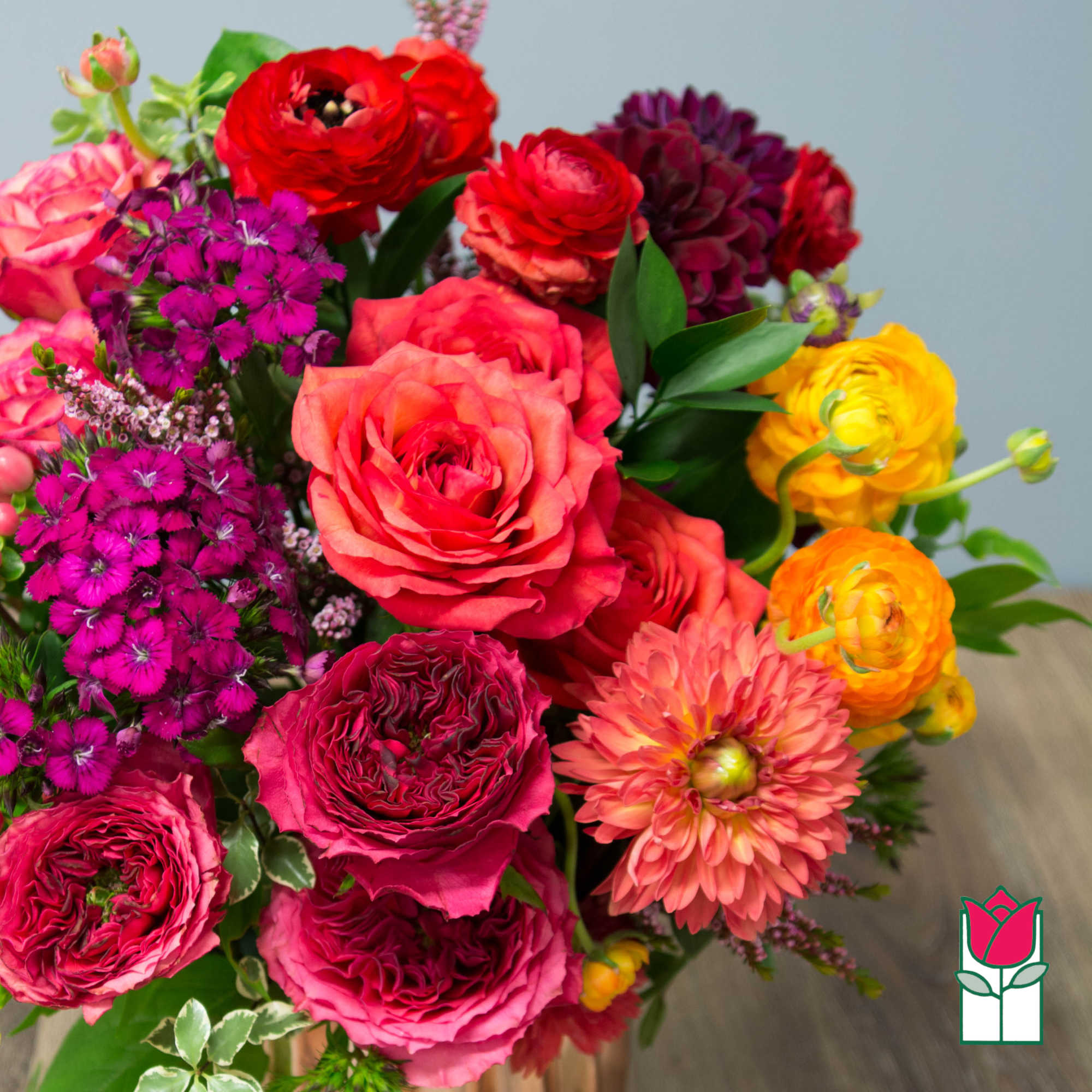 Bright mixed bouquet with pink roses, magenta blooms, and yellow flowers