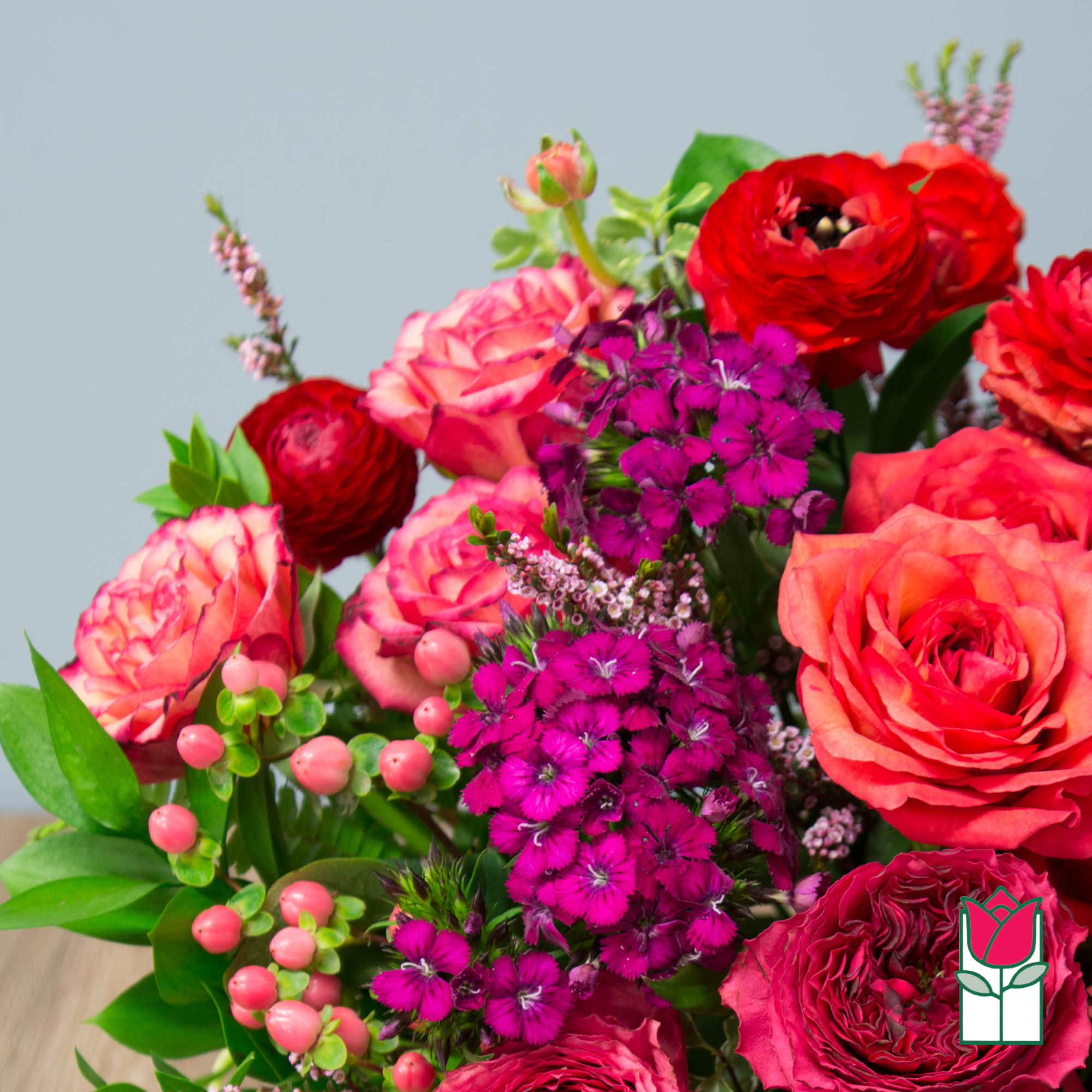 Bouquet of red and pink roses with magenta filler flowers