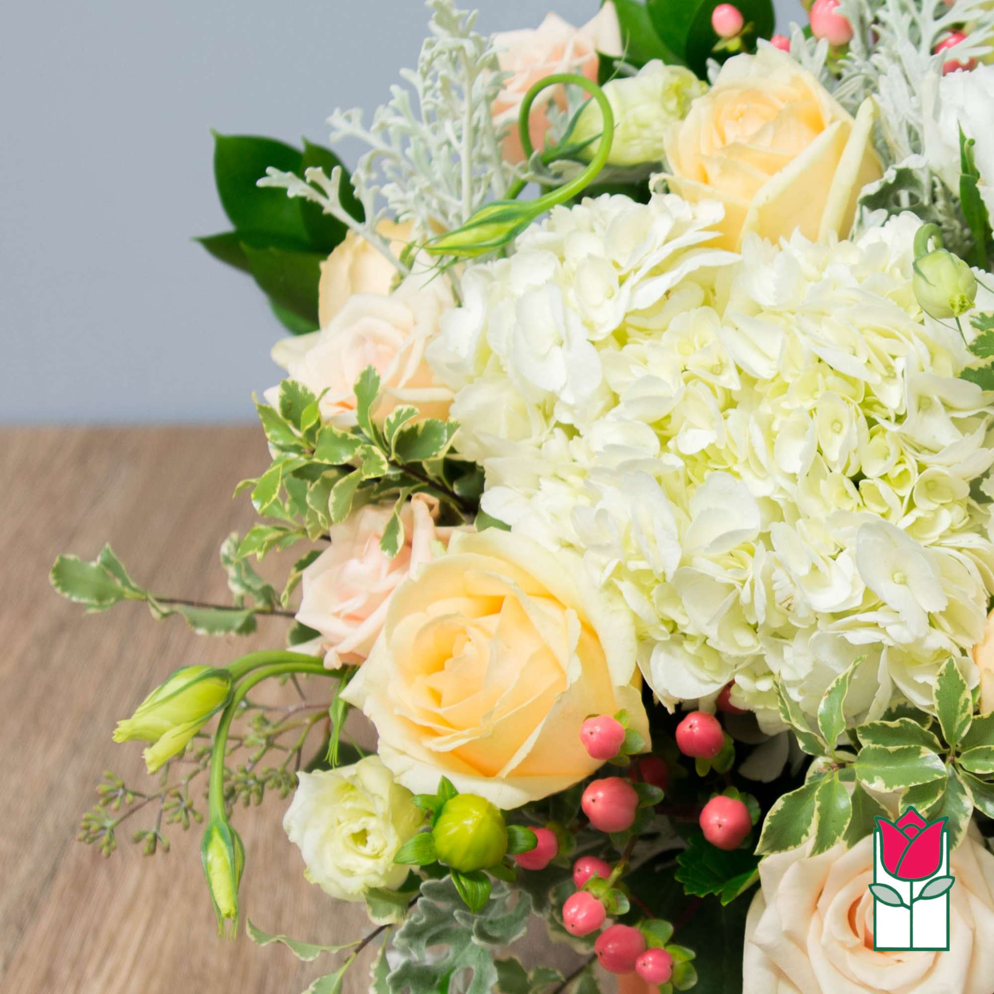 Bouquet of pale roses and white hydrangeas with pink berries
