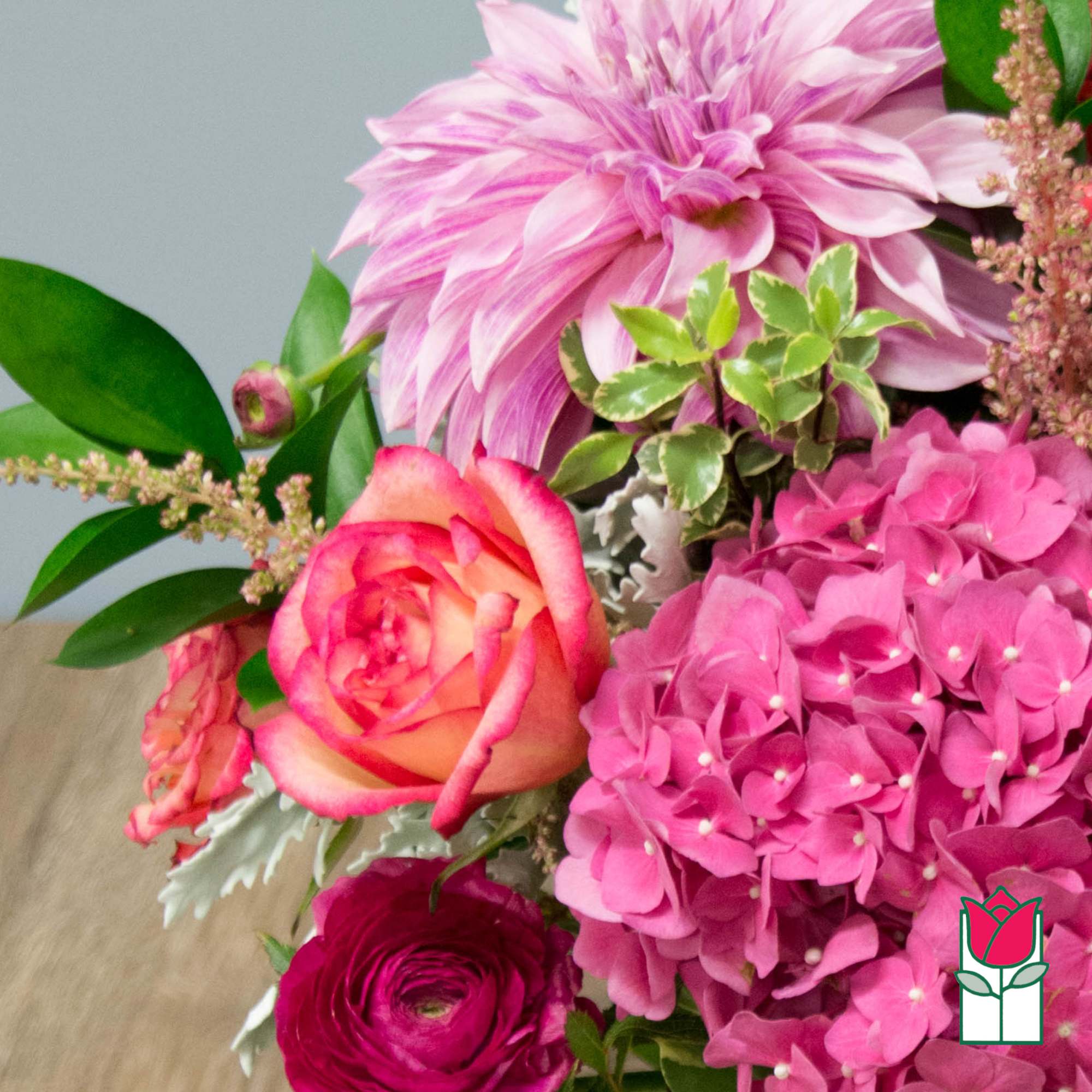 Pink floral bouquet with a large dahlia, roses, and hydrangea