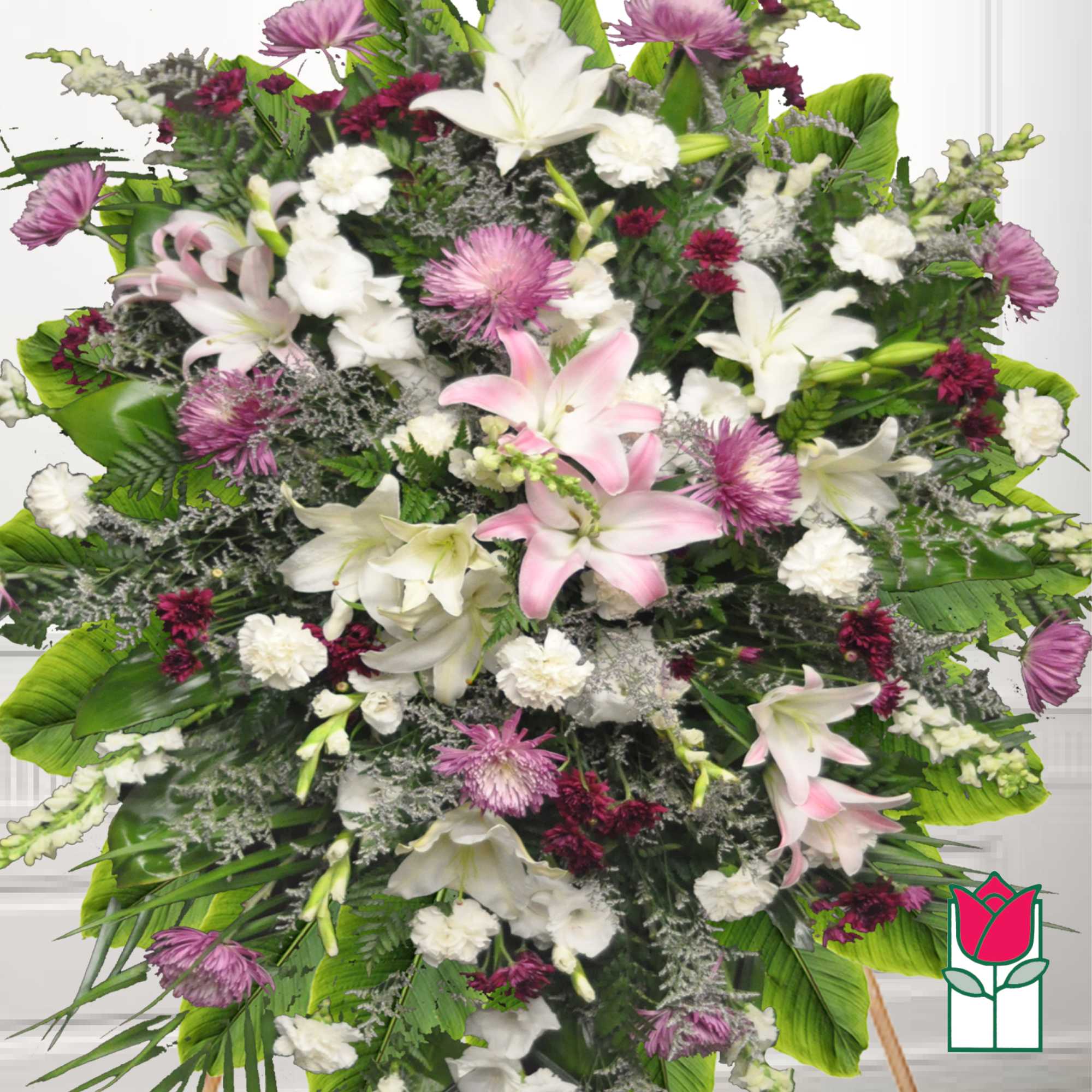 Large standing spray of lilies, carnations, and purple mums