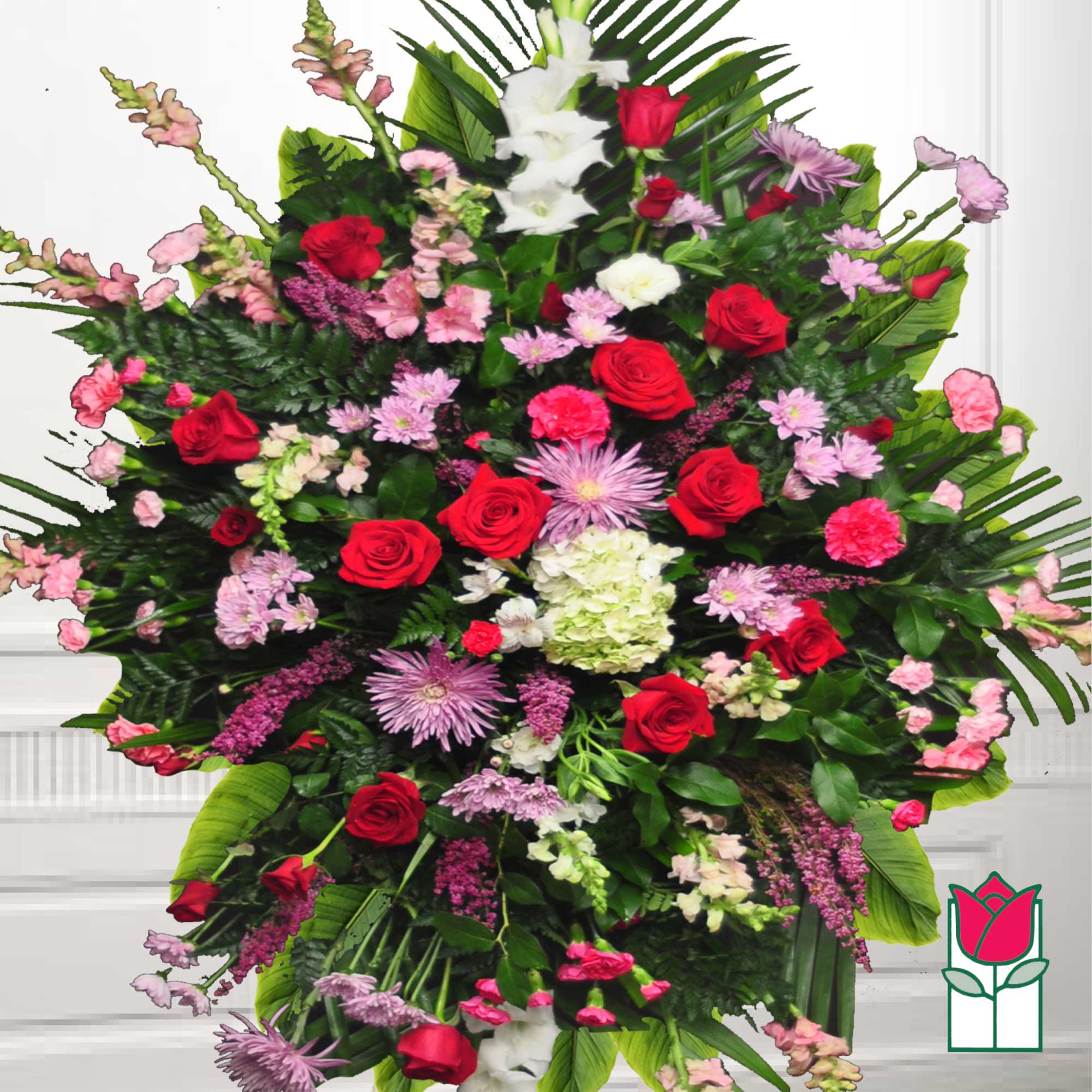 Large standing floral spray with red roses, pink flowers, and white blooms