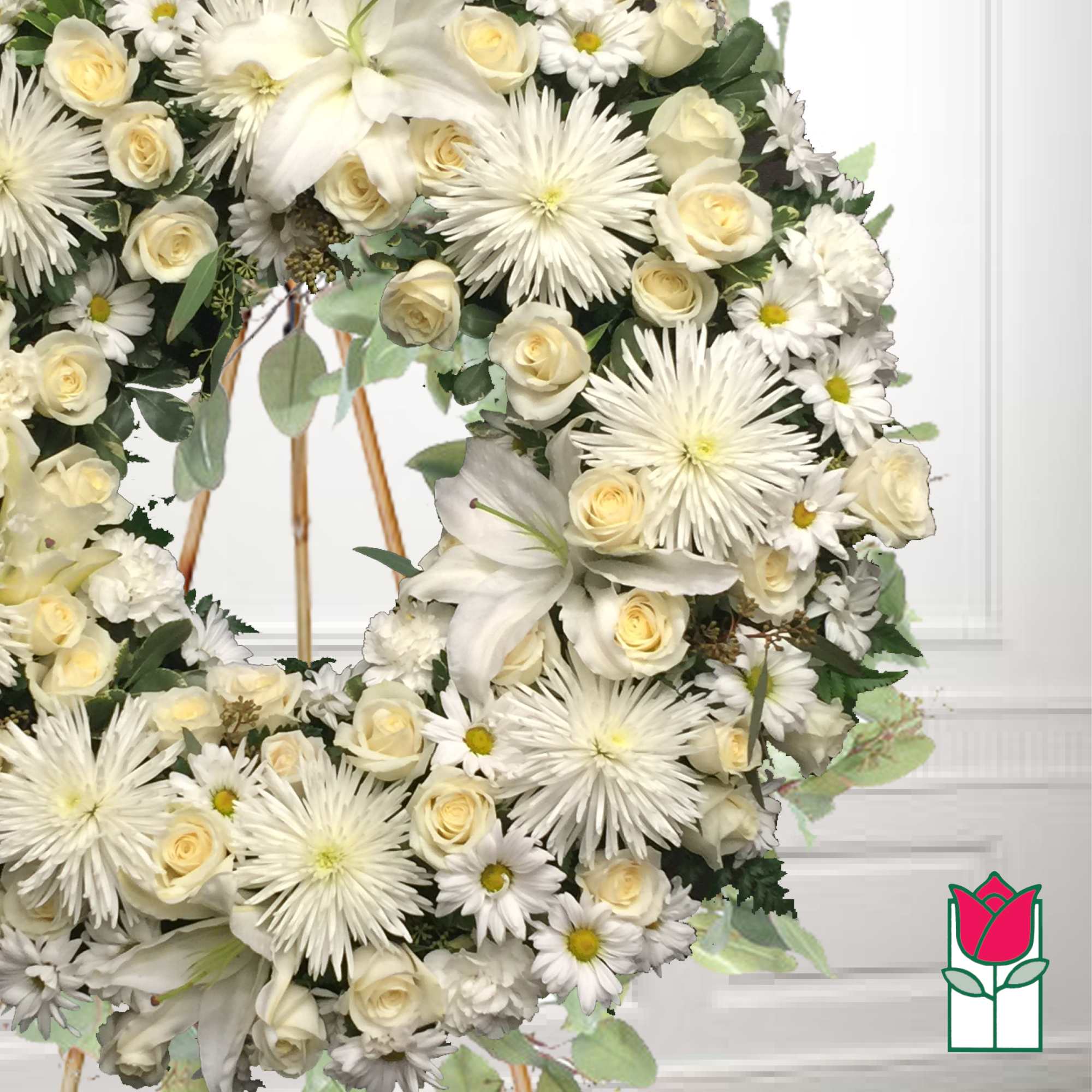 White floral wreath with roses, daisies, and lilies