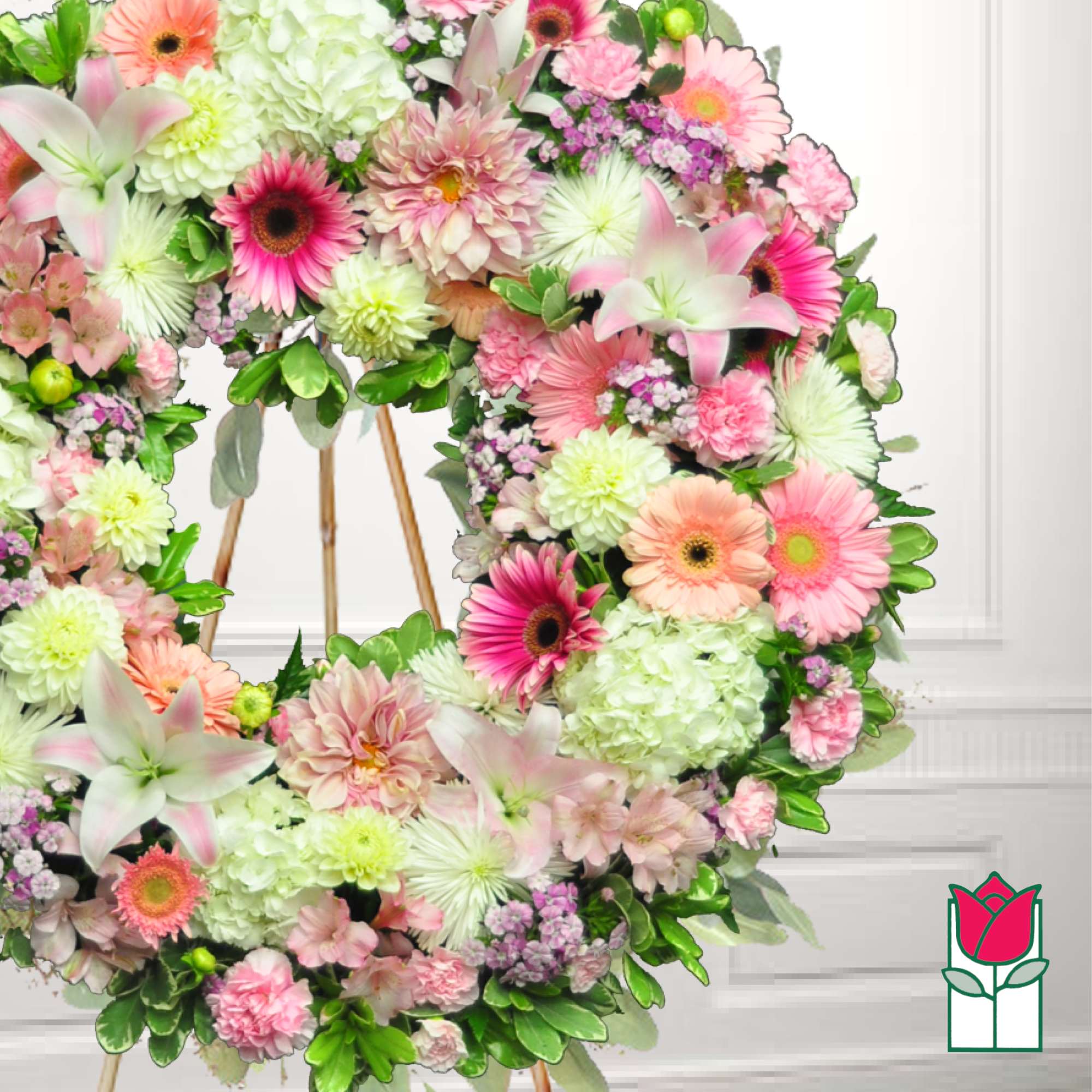 Floral wreath with pink and white mixed blooms on a stand