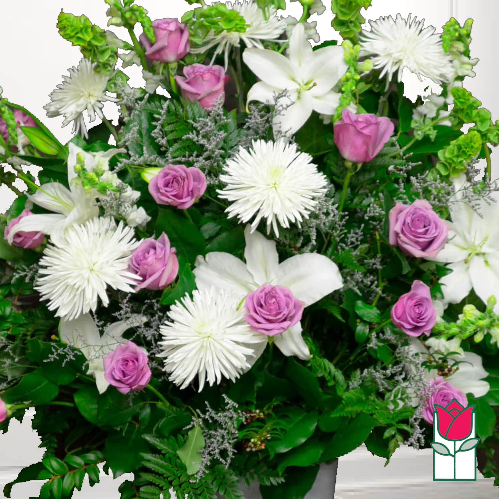 Pink roses and white lilies with white spider mums in a lush arrangement