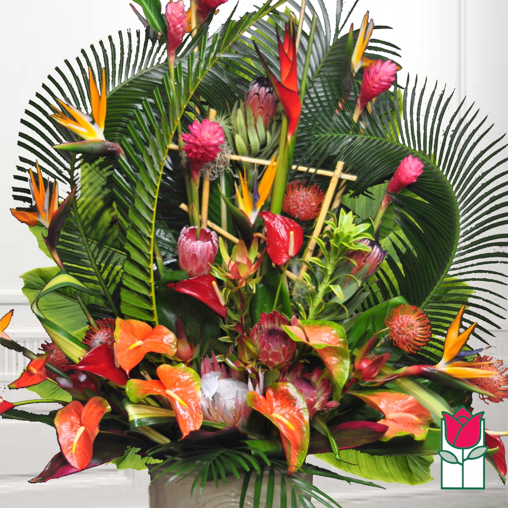 Tropical floral arrangement with orange and pink blooms in a vase