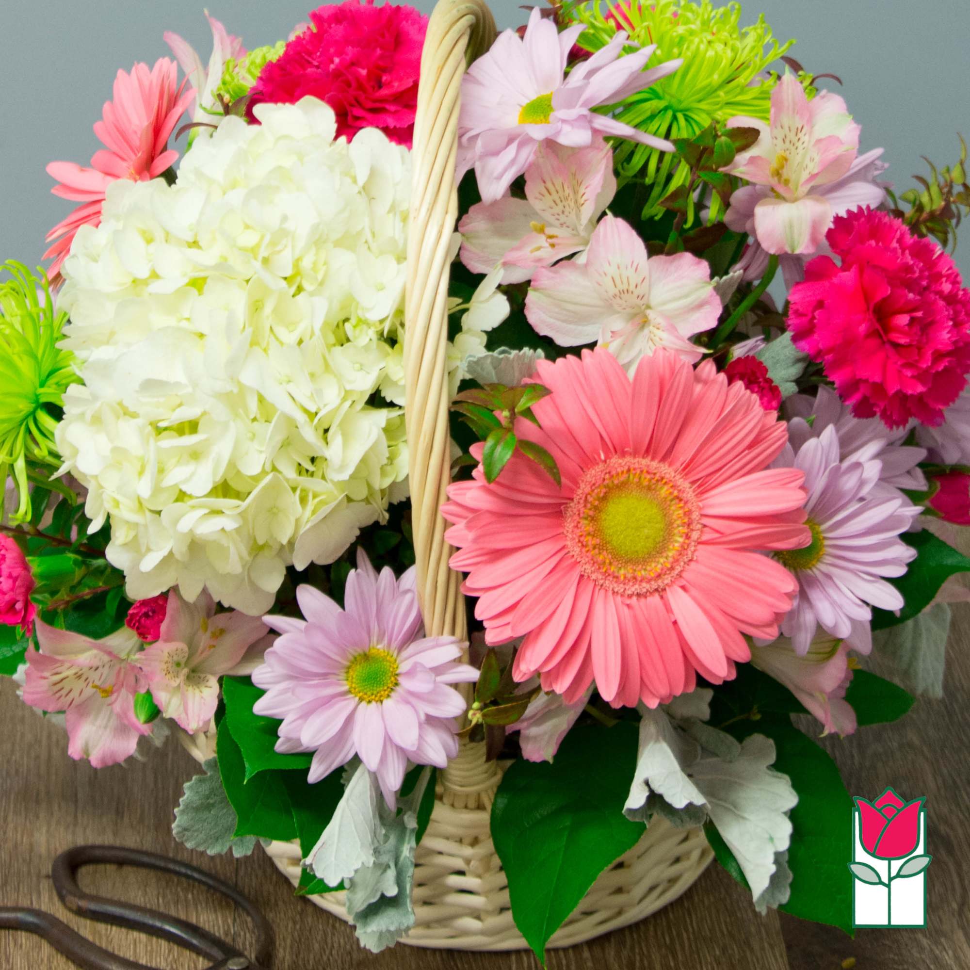 Basket of pink and white flowers with daisies and hydrangea