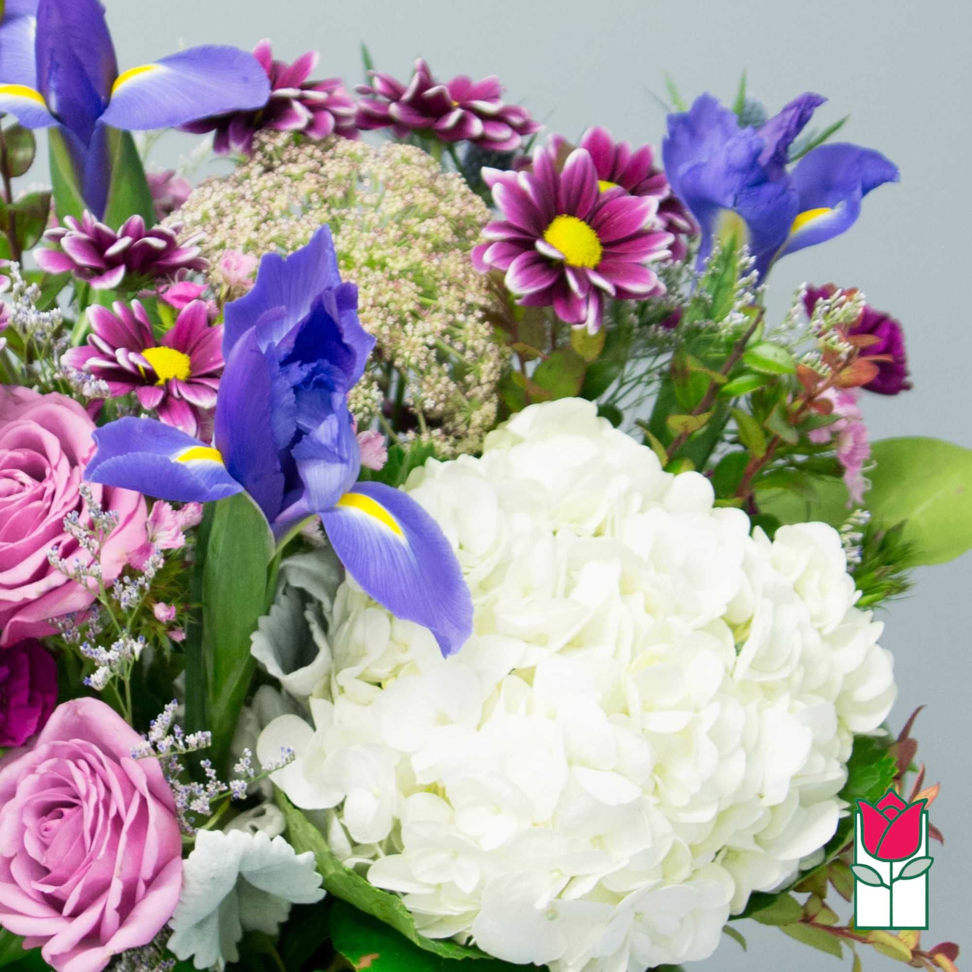 Bouquet with white hydrangea, purple irises, and pink roses
