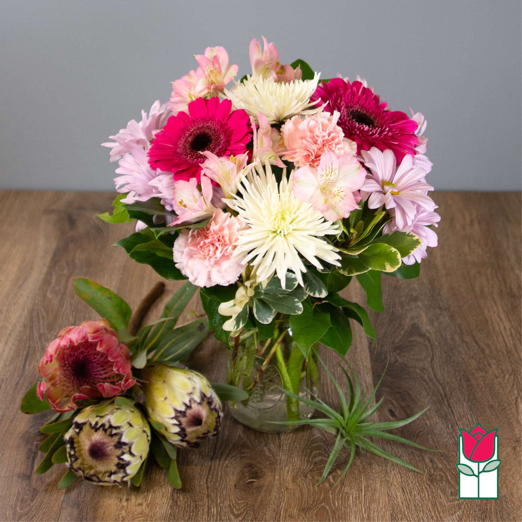 Mixed bouquet of pink and white flowers in a glass vase