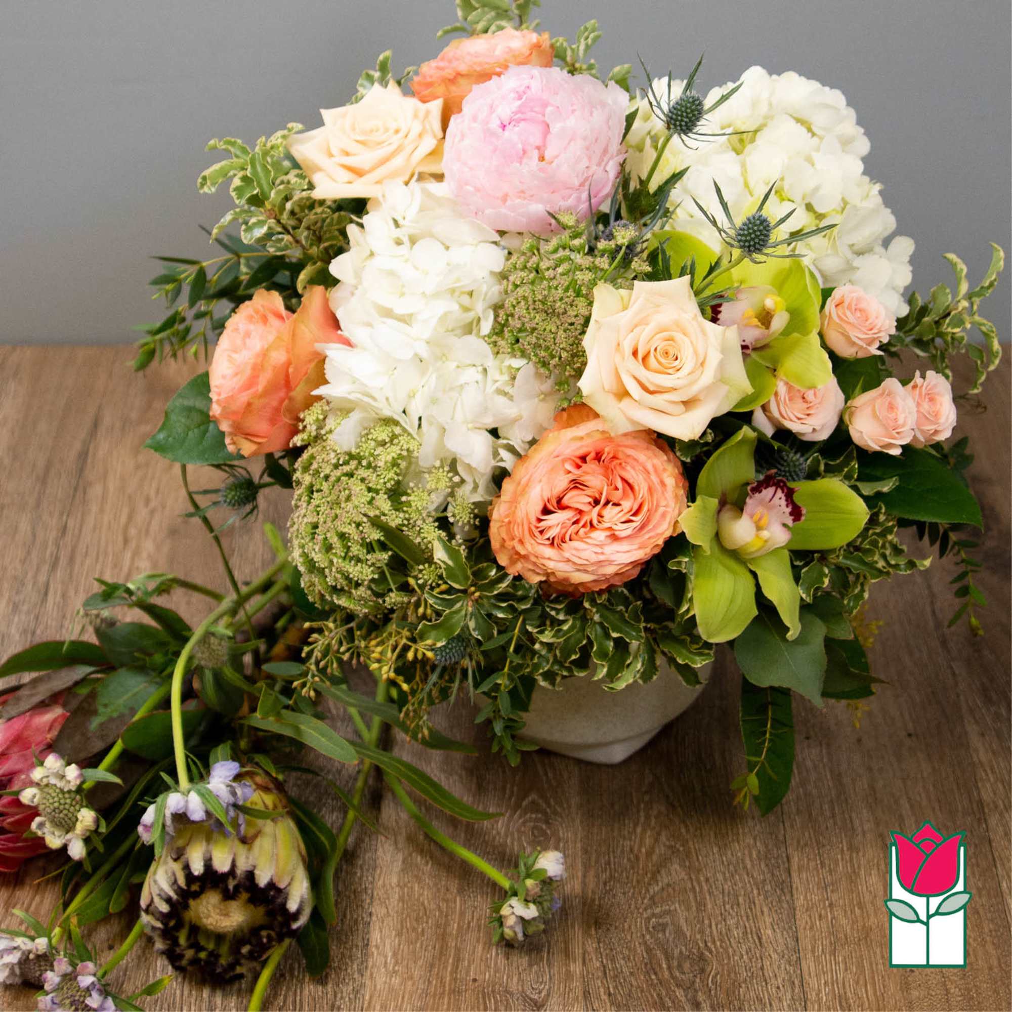 Mixed bouquet of peach, pink, and white flowers in a low vase, photo 2 of 5
